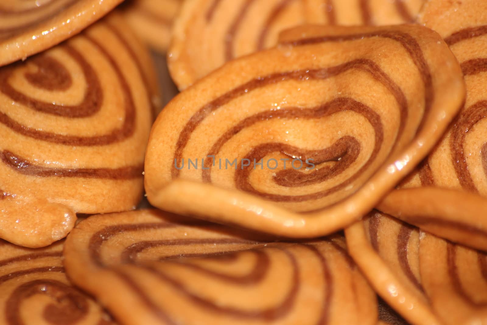 Closeup view with selective focus of a large number of round cookies by Photochowk