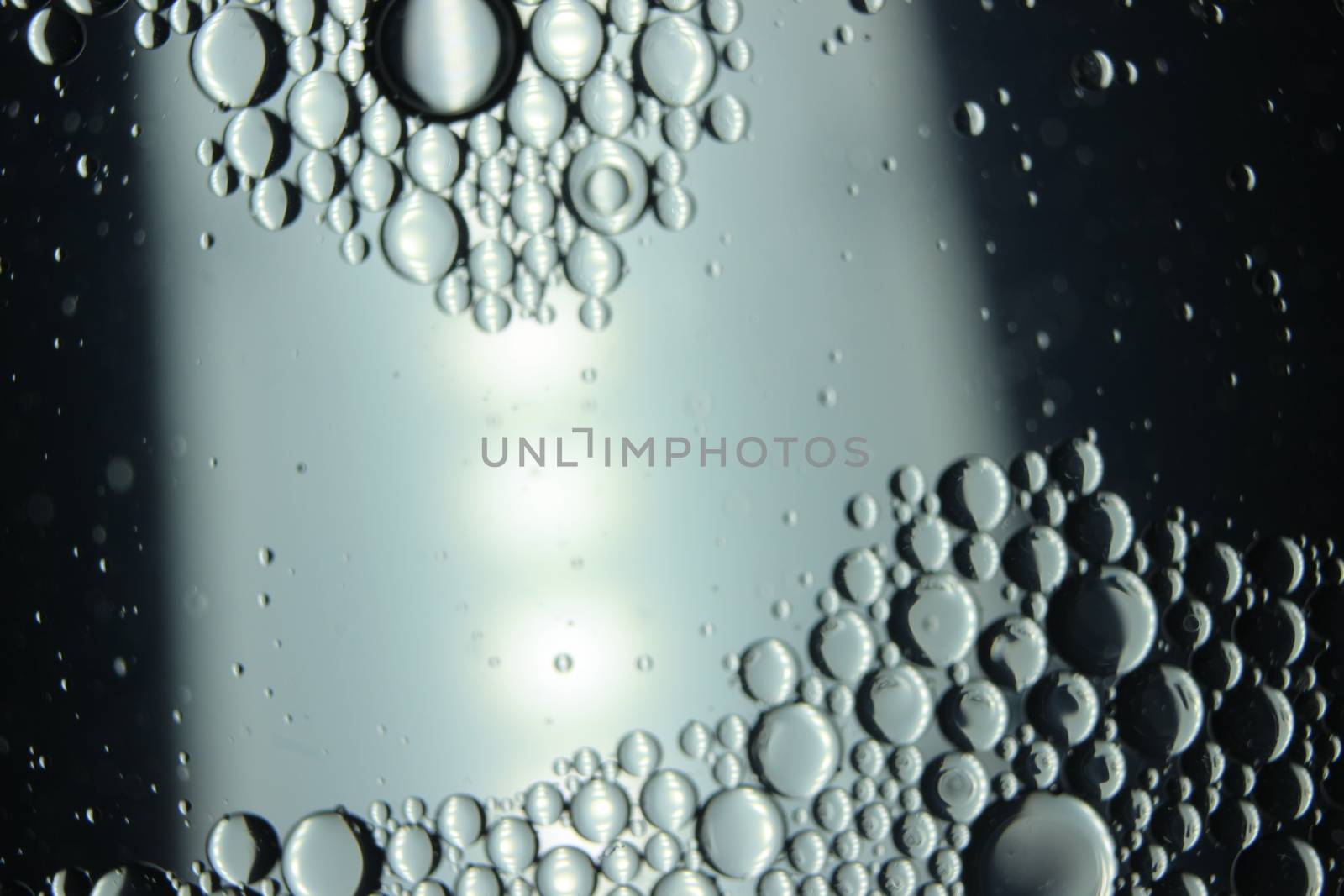 abstract macro background of oil circles floating over water surface . by Photochowk