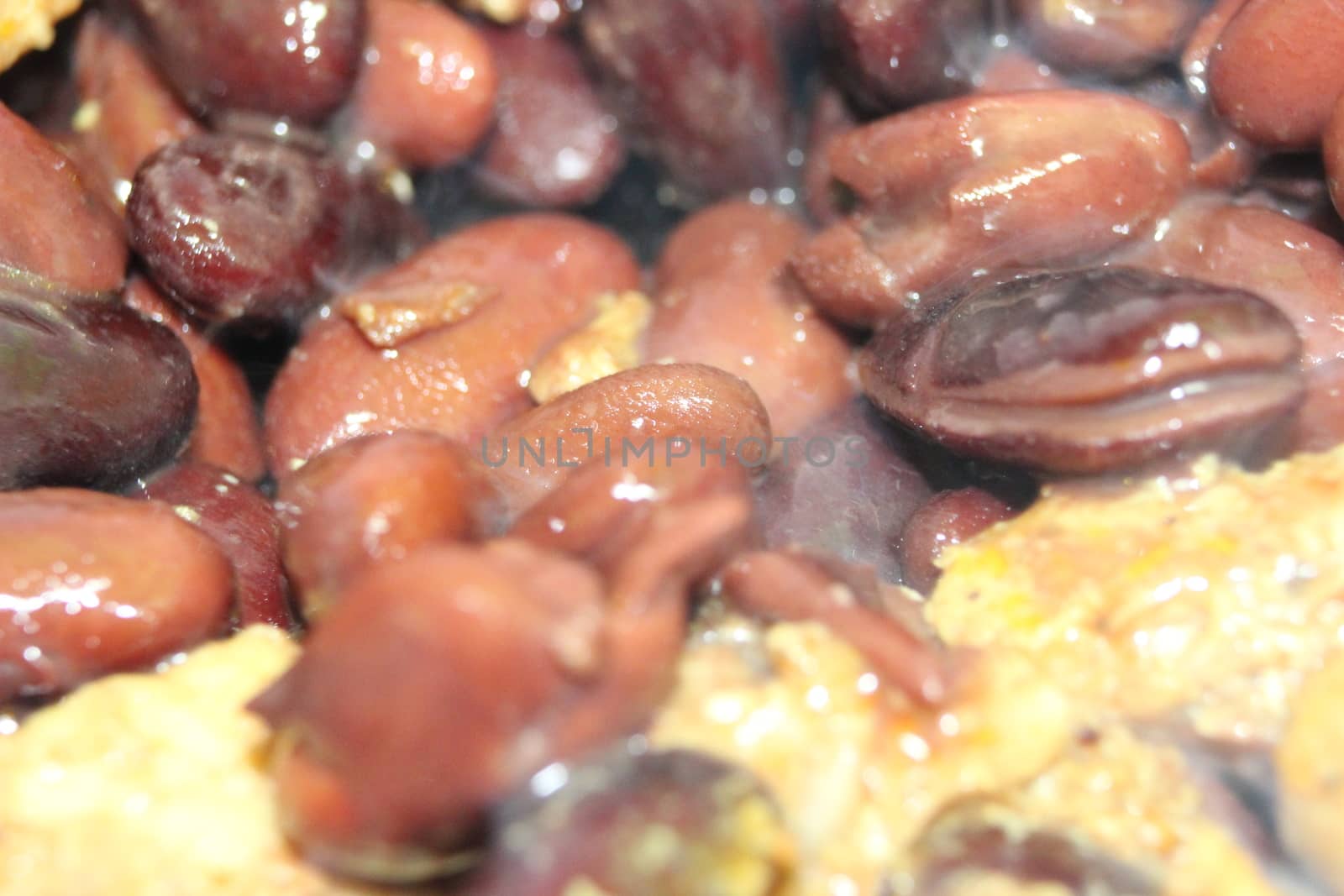 close up picture of baked red kidney bean served with soup by Photochowk