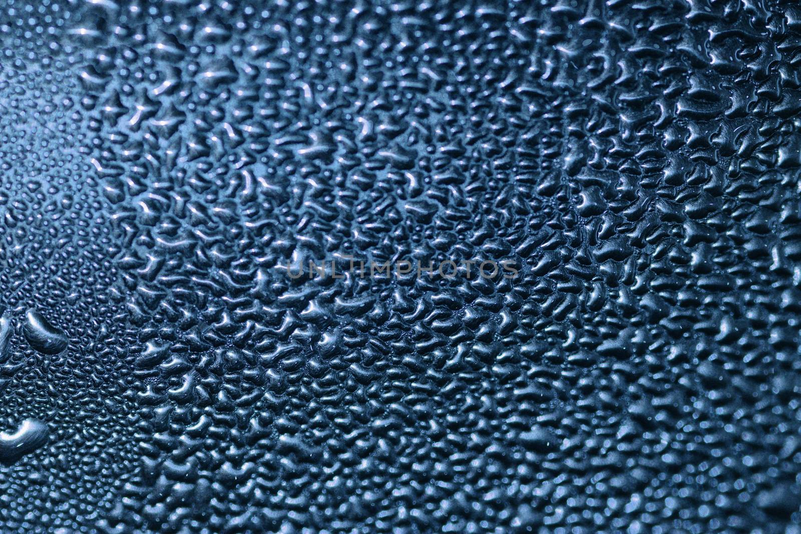 Deail of metal surface covered in water drops - abstract background