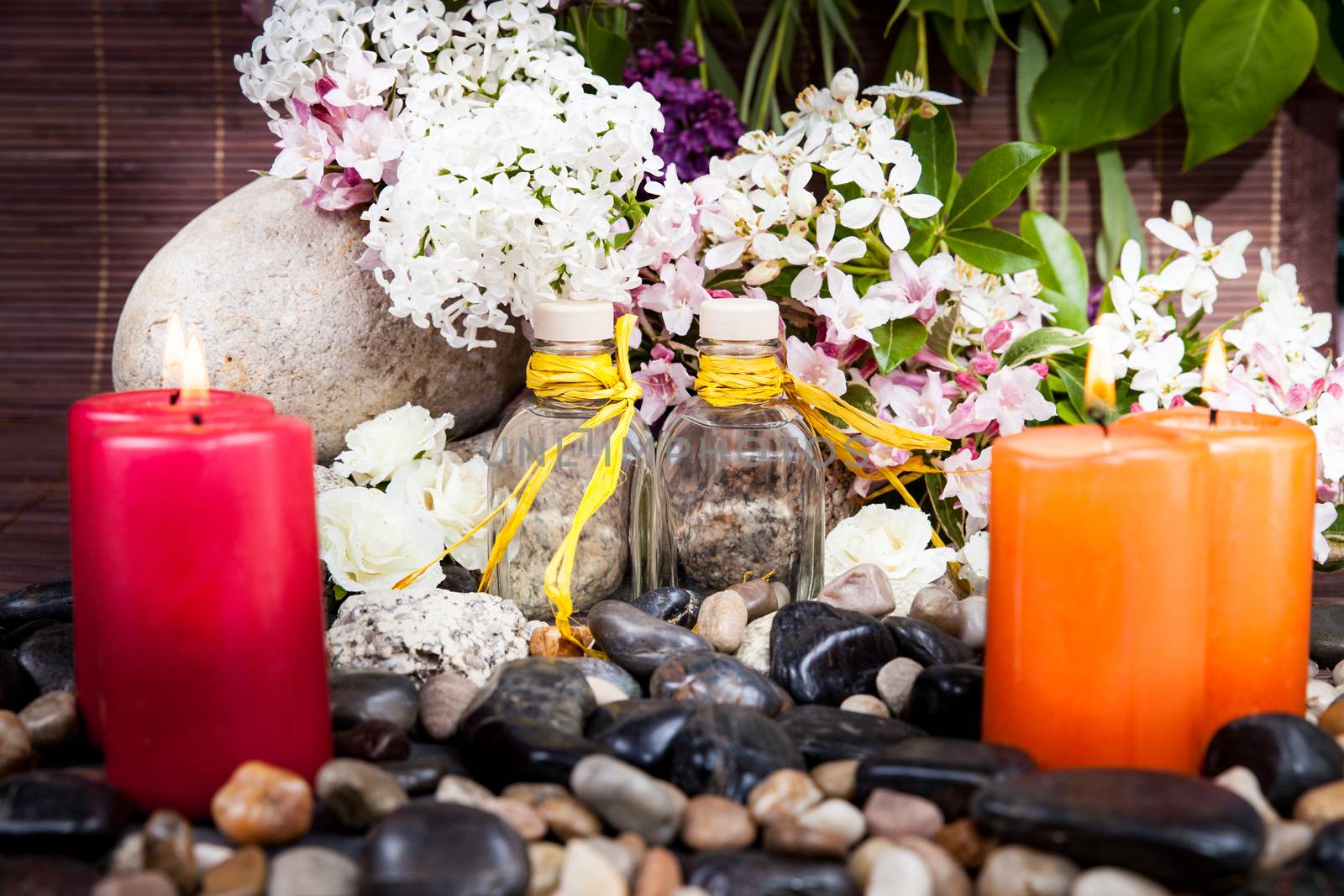 Aromatherapy, spa, beauty treatment and wellness background with massage stone, flowers, burning candles... spa concept