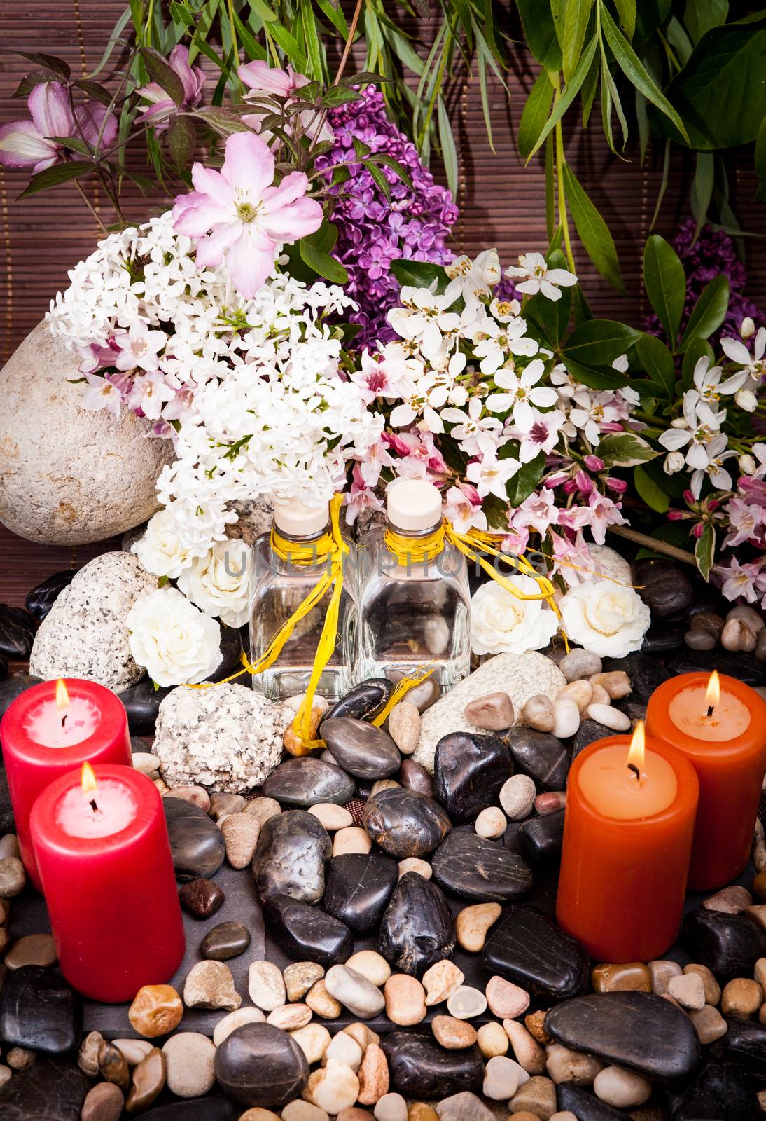 Aromatherapy, spa, beauty treatment and wellness background with massage stone, flowers, burning candles... spa concept