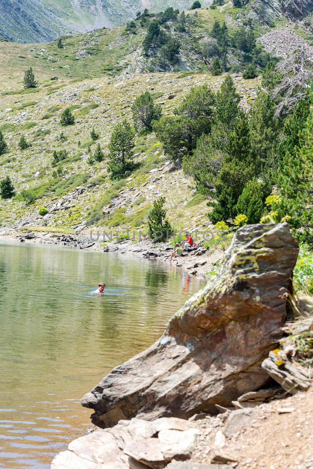 Coma Pedrosa, Andorra : 02 August 2020 : 
Group of tourists resting at Lago de les Truites in Andorra Pyrenees in summer 2020.