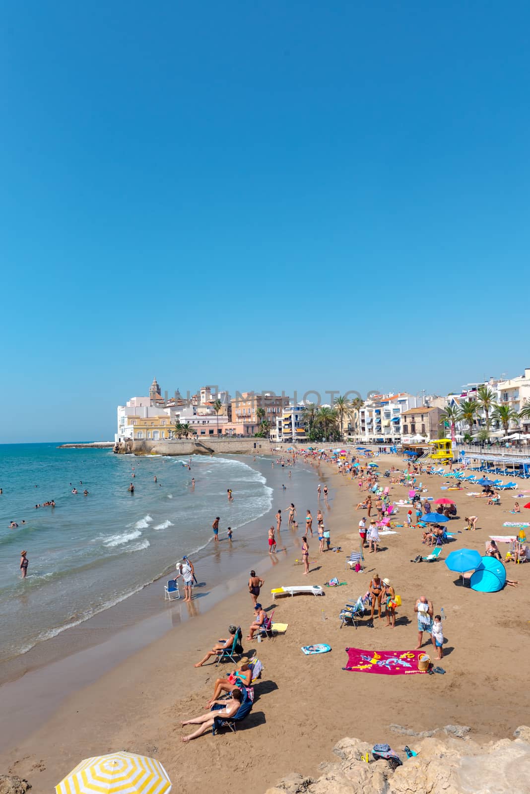Sitges, Catalonia, Spain: July 28, 2020: People in the beach in Sitges in summer 2020.