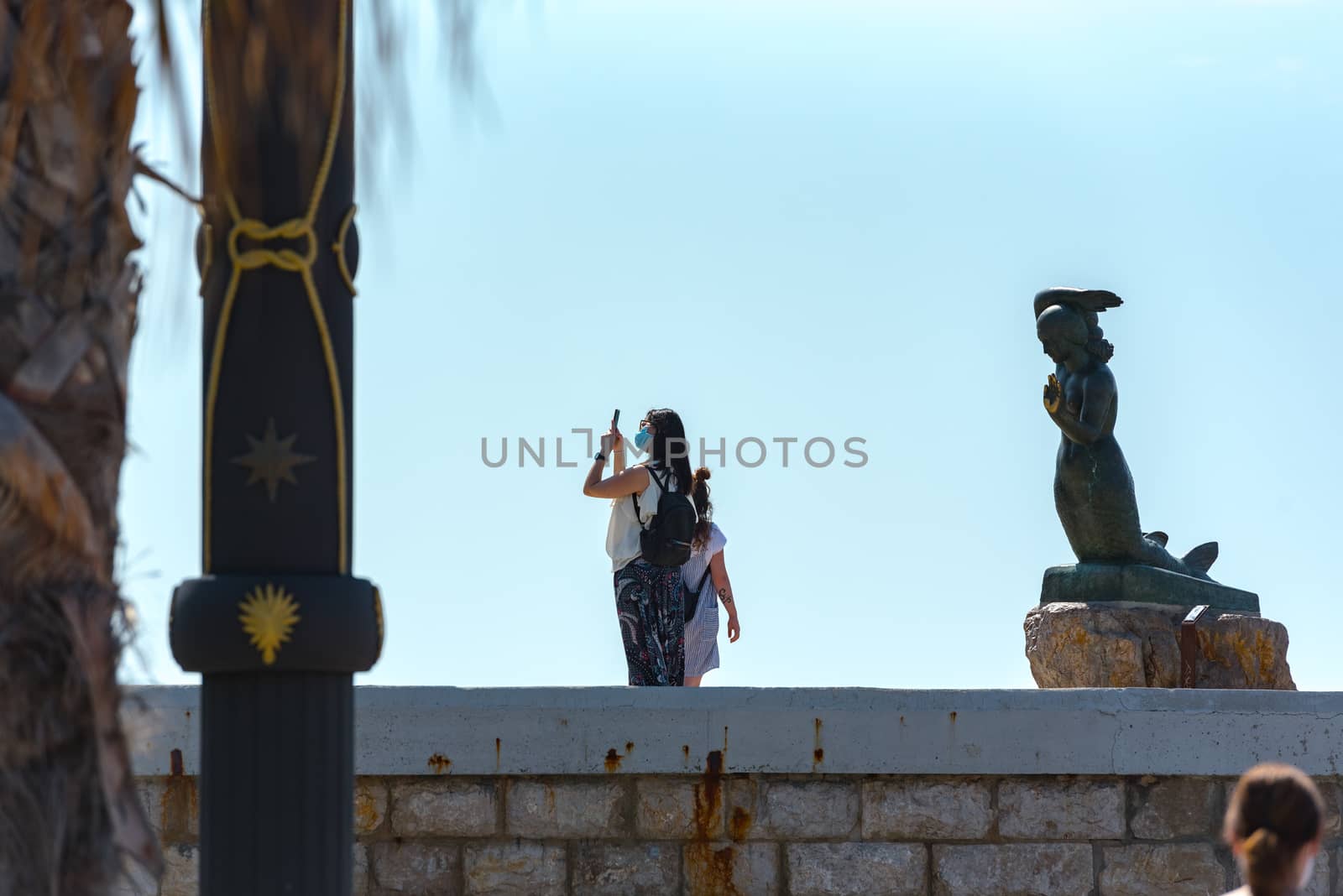 Tourist take picture on the beach in Sitges in summer 2020. by martinscphoto