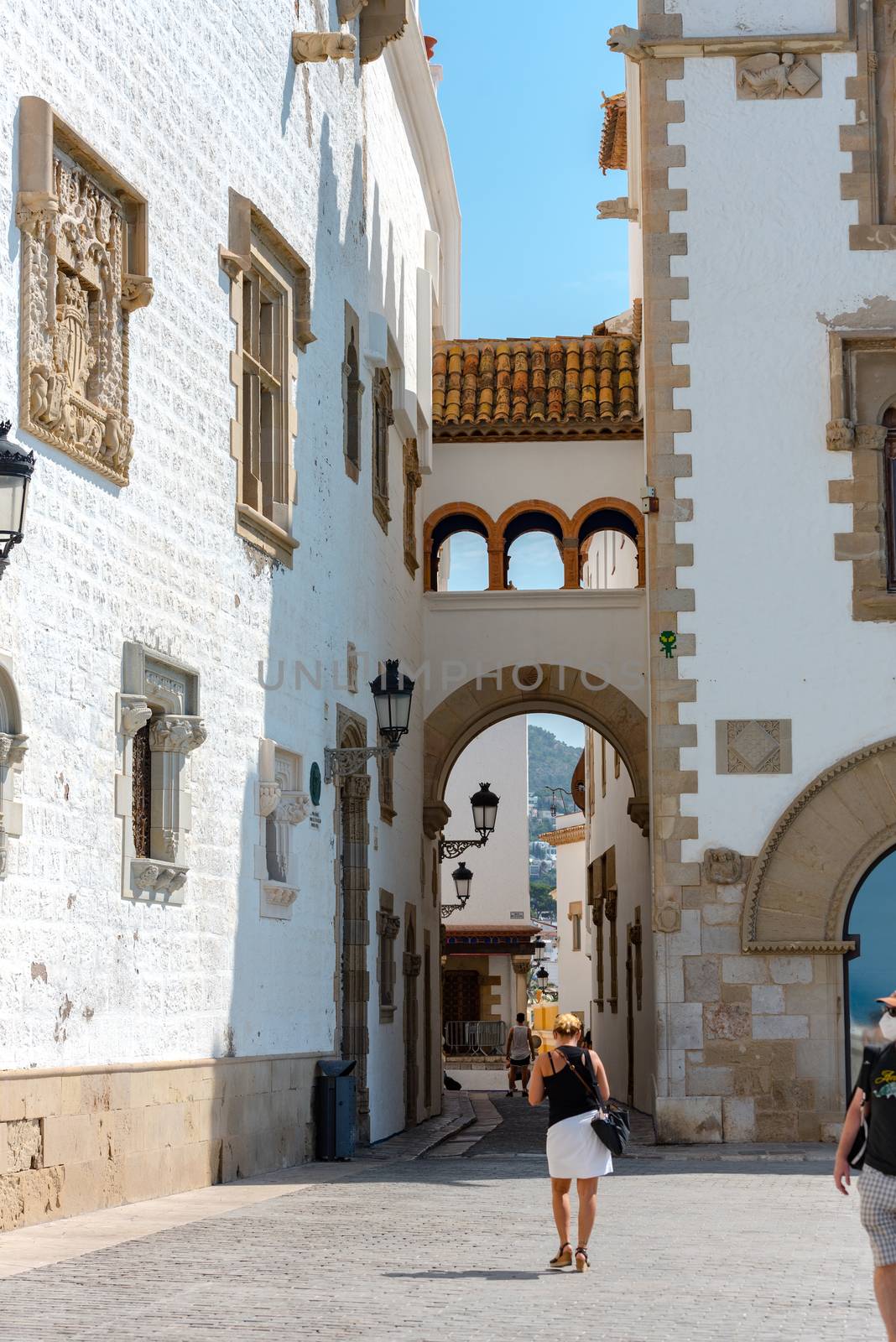 People walking in the old town in Sitges in summer 2020. walking by martinscphoto