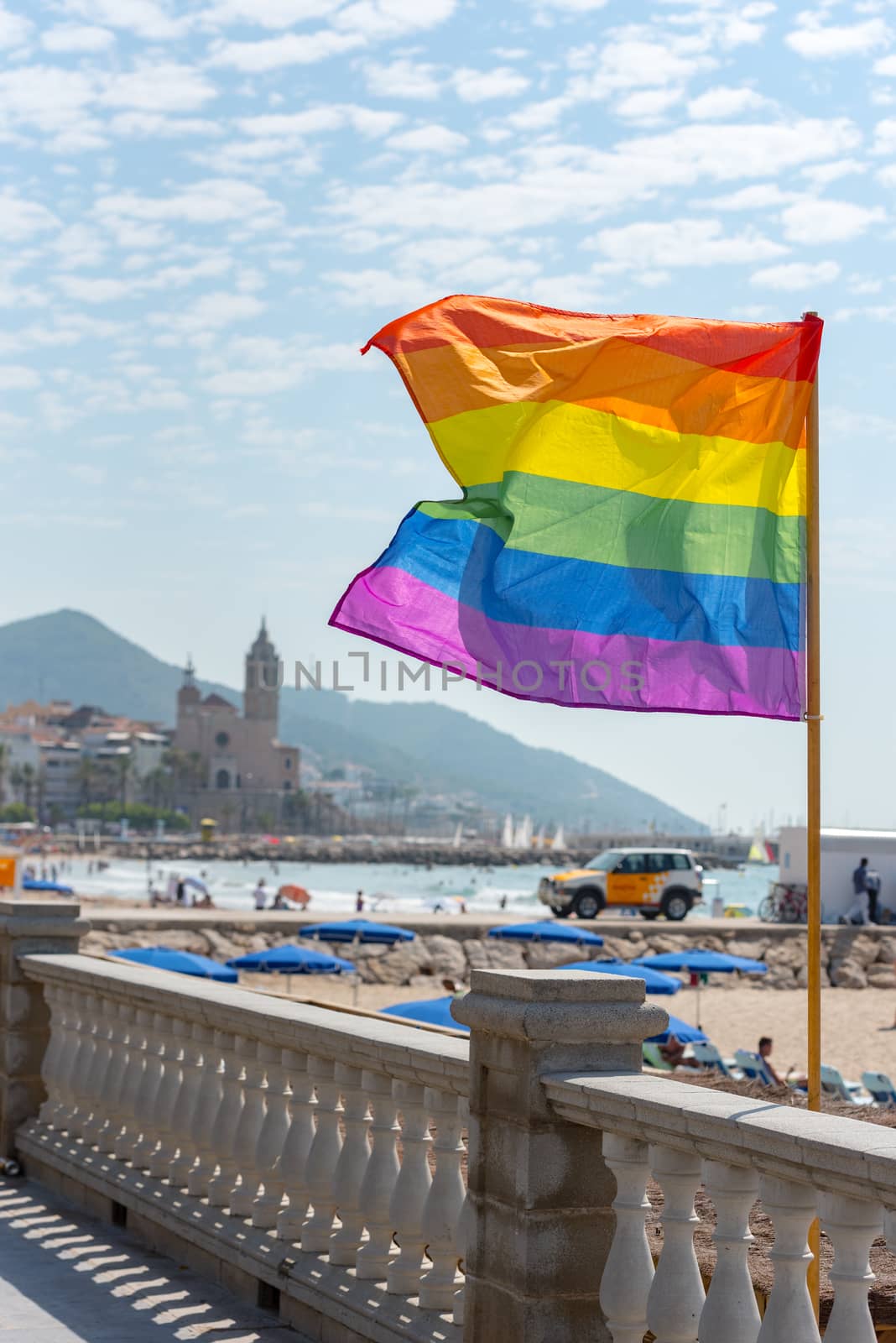 Sitges, Catalonia, Spain: July 28, 2020: Flag gay whit People on the Paseo Maritimo in the city of Sitges in the summer of 2020.