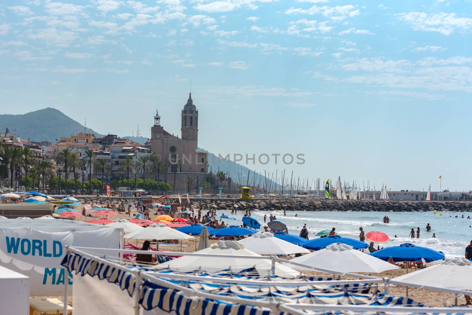 Sitges, Catalonia, Spain: July 28, 2020: People on the Paseo Maritimo in the city of Sitges in the summer of 2020.