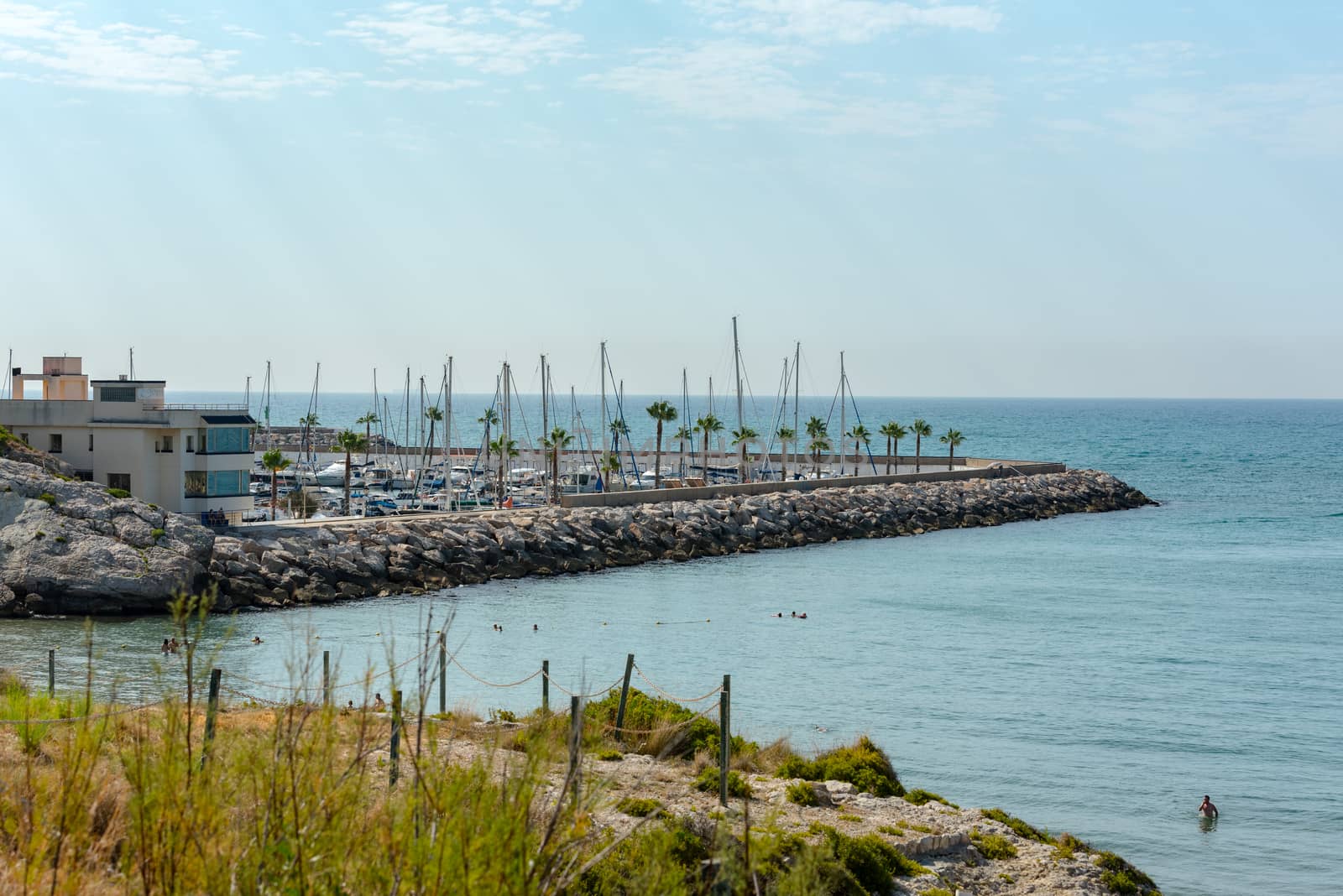 Sitges, Catalonia, Spain: July 28, 2020: Port of Sitges. People in the beach in Sitges in summer 2020.