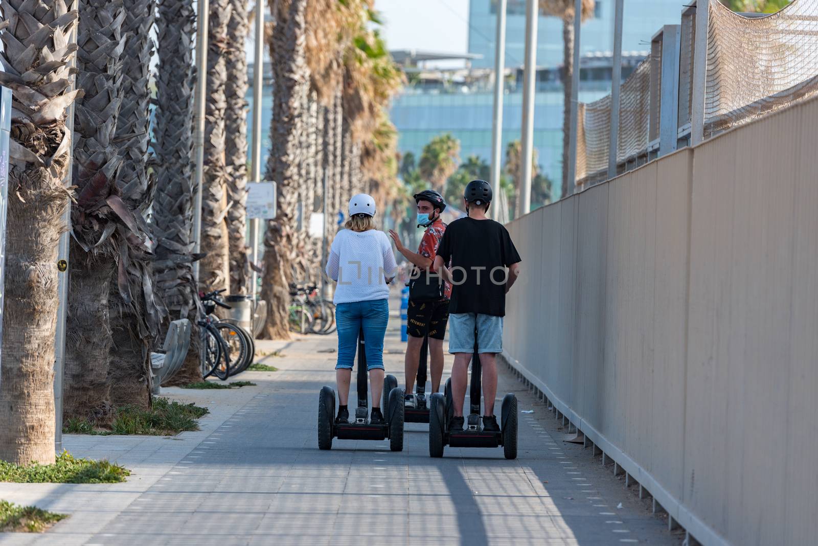 Barcelona, Spain - July 28 2020:  People walking through empty streets after COVID 19 LA Barceloneta in Barcelona, Spain.