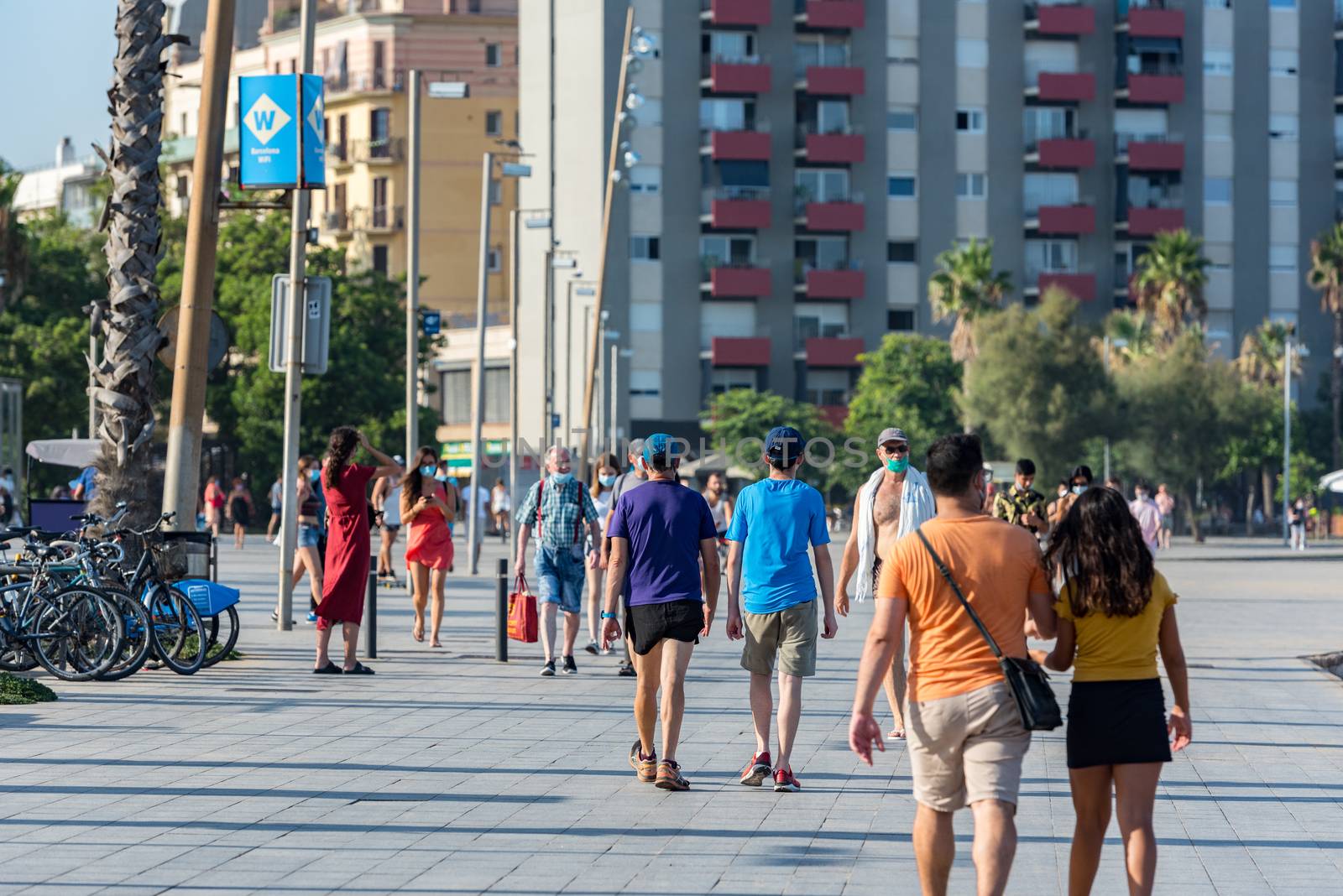 Barcelona, Spain - July 28 2020:  People walking through empty streets after COVID 19 LA Barceloneta in Barcelona, Spain.