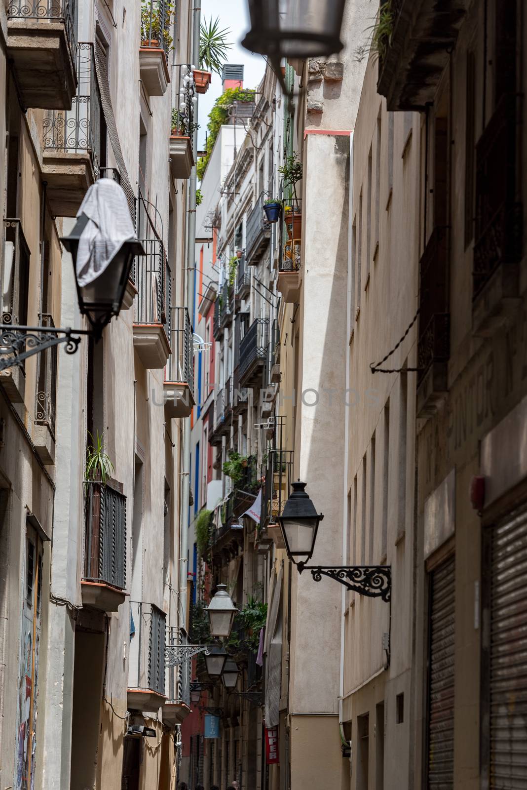 Barcelona, Spain - July 28 2020:  People walking through empty streets after COVID 19 in Barcelona, Spain.