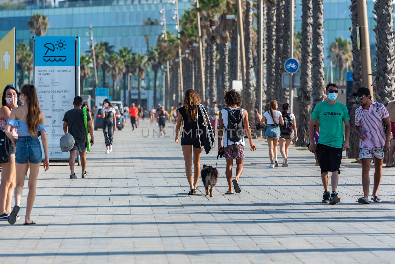 Barcelona, Spain - July 28 2020:  People walking through empty streets after COVID 19 LA Barceloneta in Barcelona, Spain.