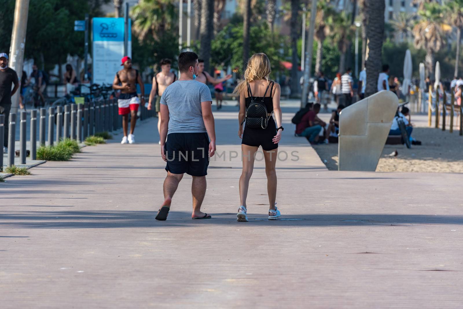 Barcelona, Spain - July 28 2020:  People walking through empty streets after COVID 19 LA Barceloneta in Barcelona, Spain.