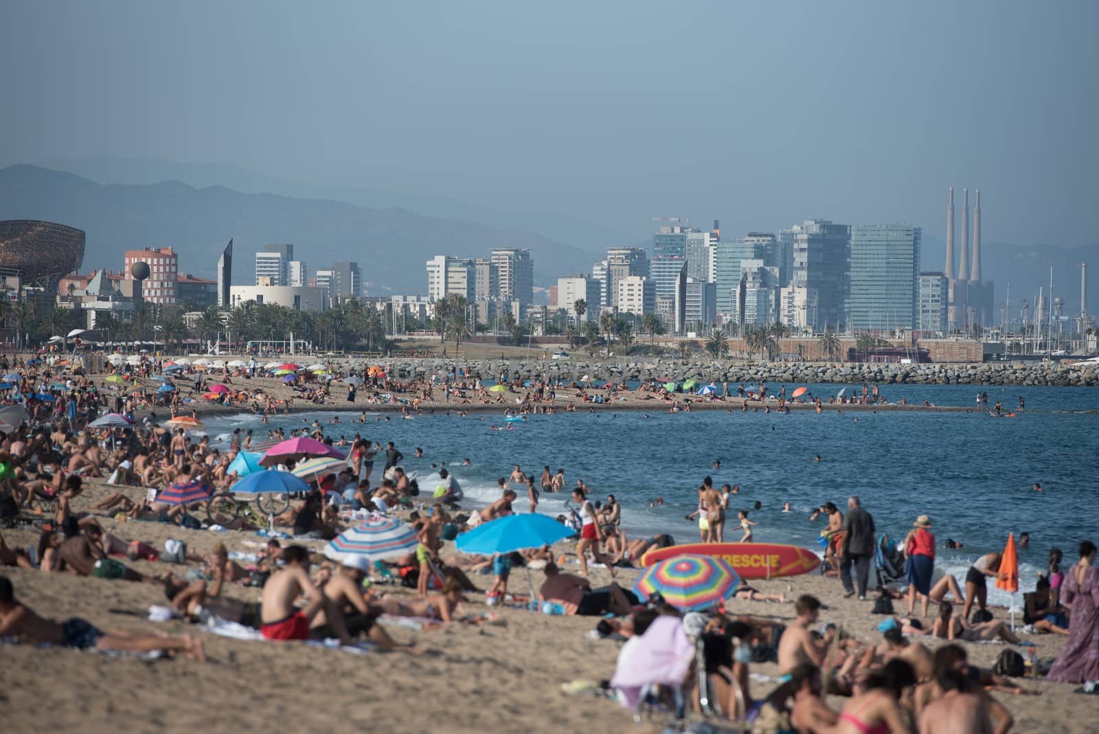 Barcelona, Spain - July 28 2020:  People in the Barceloneta Beach after COVID 19 La Barceloneta in Barcelona, Spain.