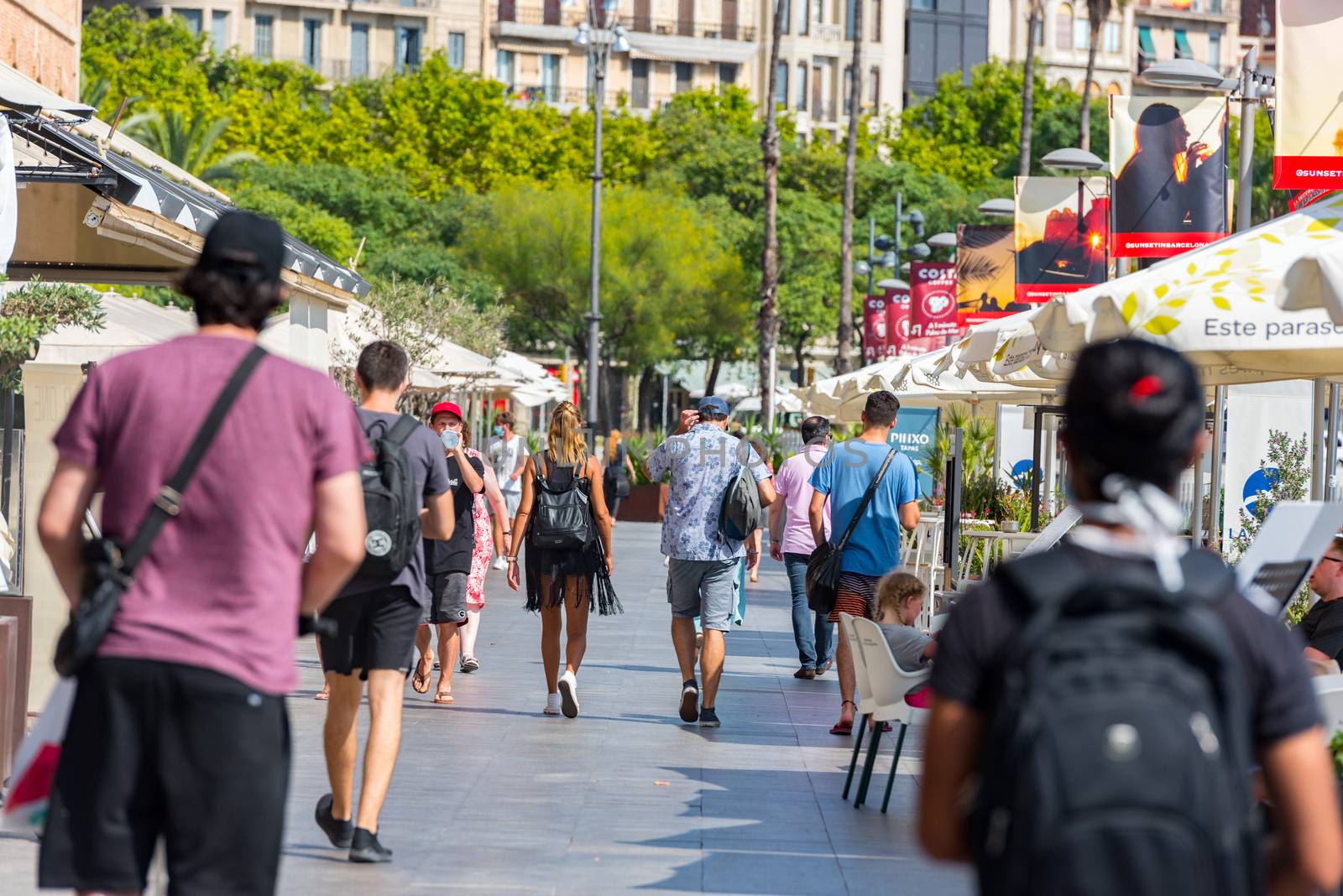 Barcelona, Spain - July 28 2020:  People walking through empty streets after COVID 19 LA Barceloneta in Barcelona, Spain.