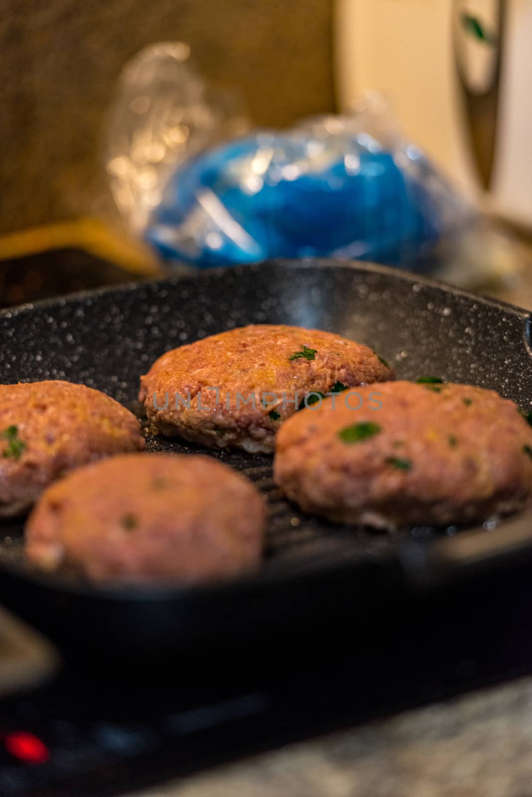 Grilled burgers with dancing flames cooked to perfection.