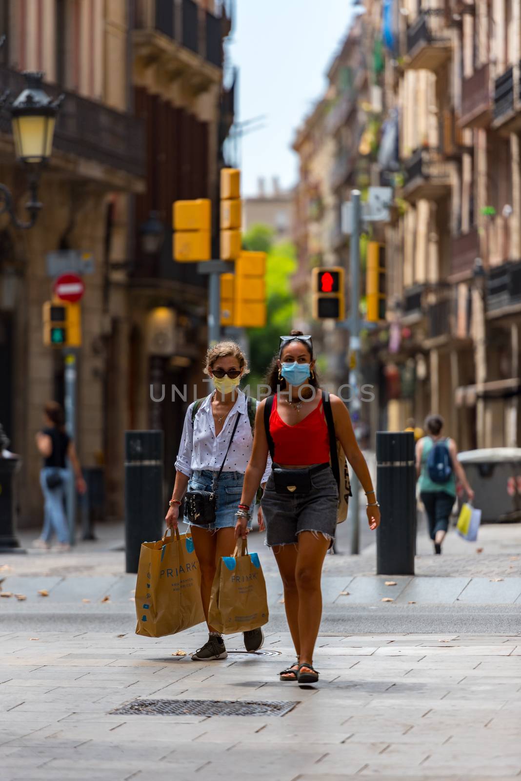 People walking through empty streets after COVID 19 in Barcelona by martinscphoto