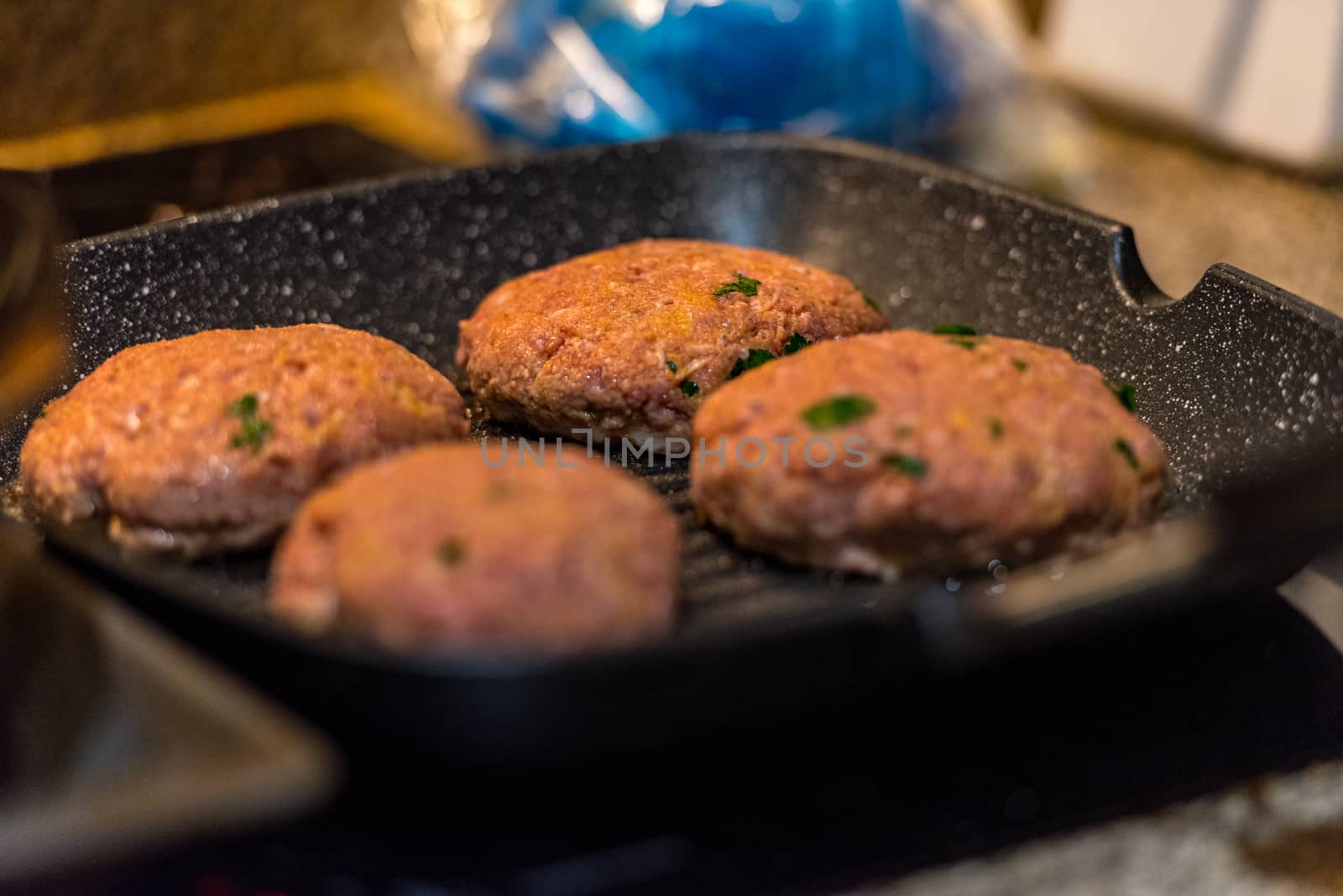 Grilled burgers with dancing flames cooked to perfection by martinscphoto