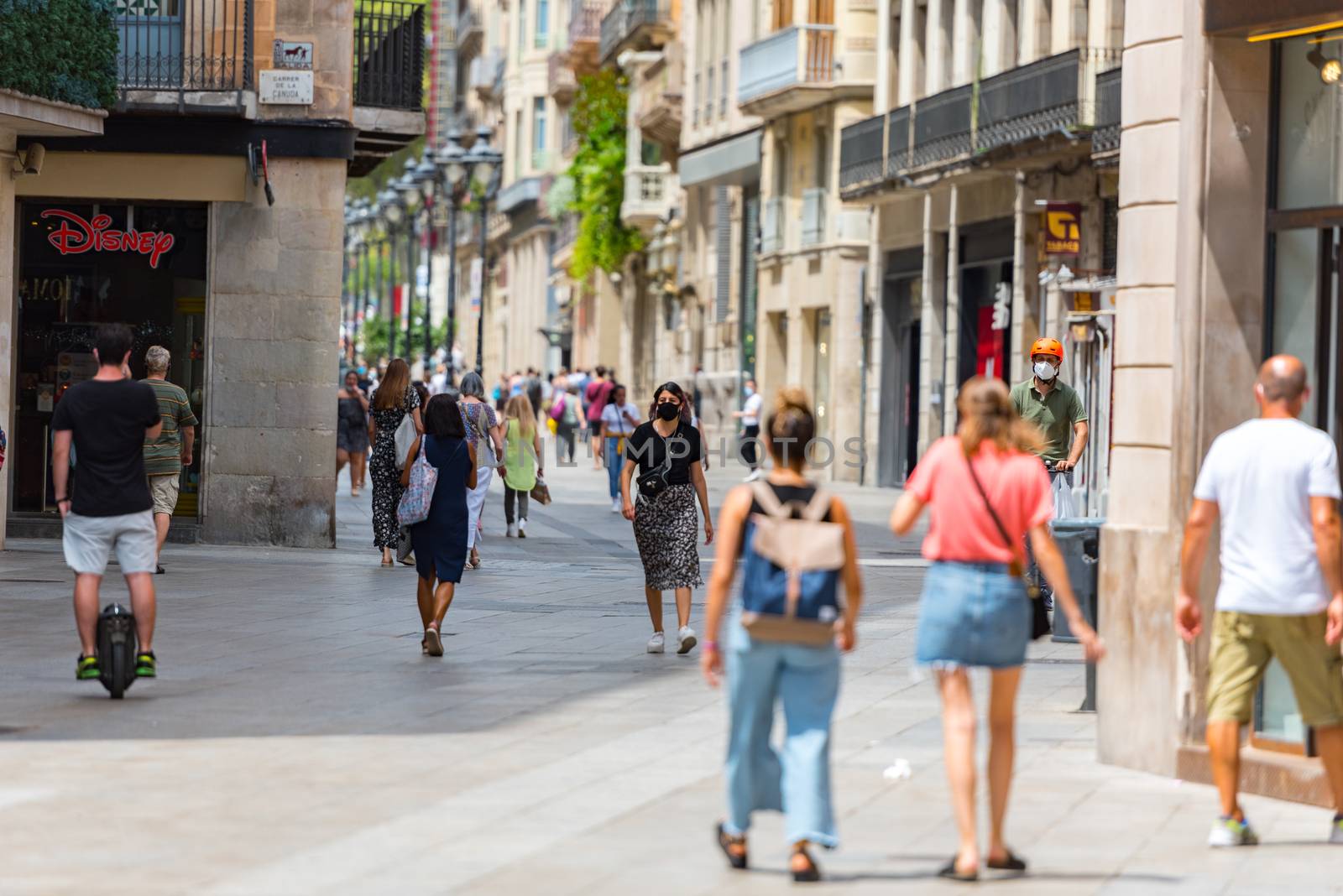 People walking through empty streets after COVID 19 in Barcelona by martinscphoto