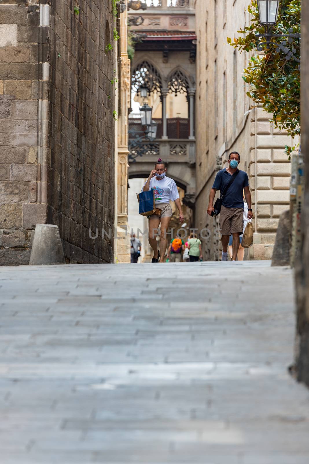 People walking through empty streets after COVID 19 in Barcelona by martinscphoto