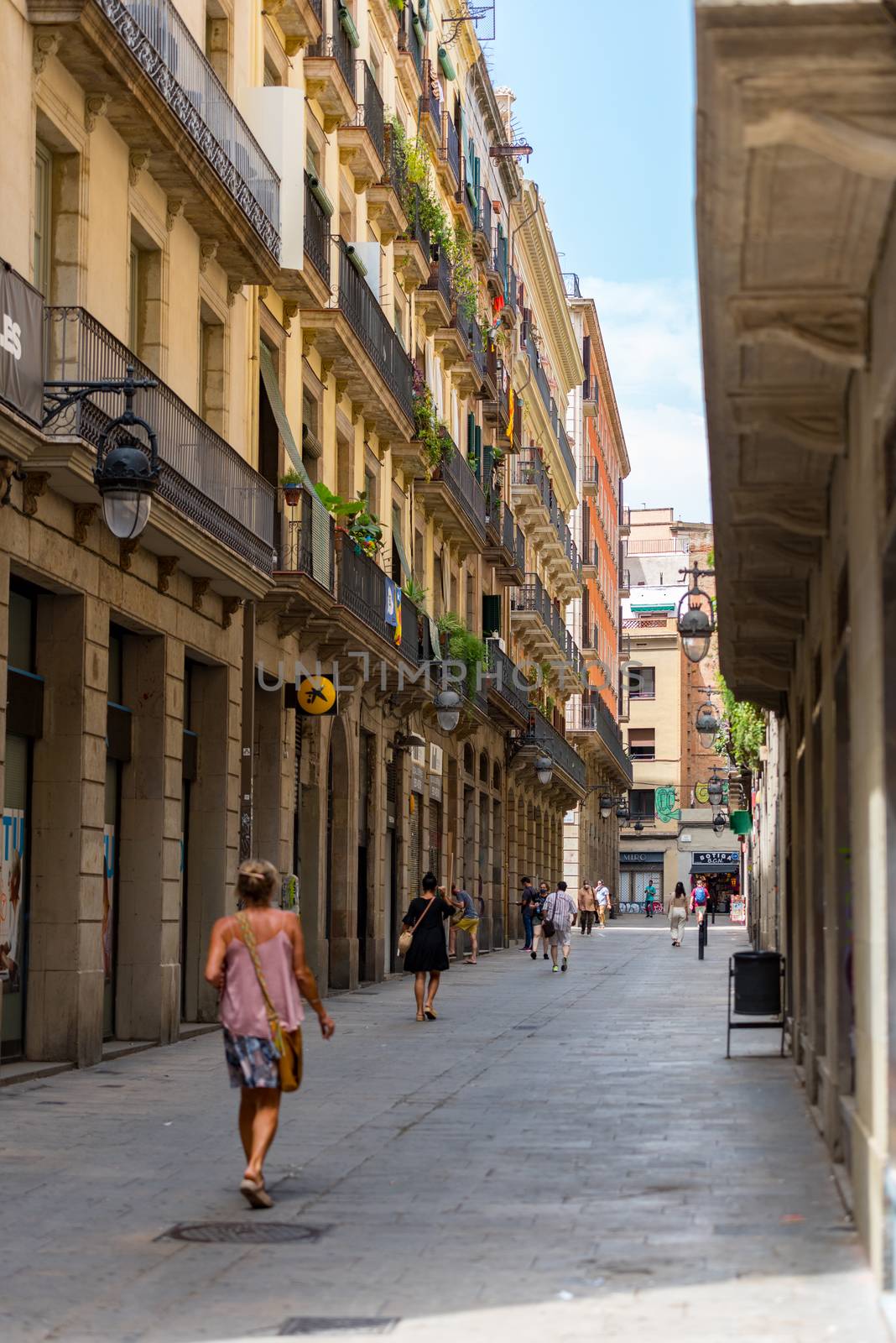 People walking through empty streets after COVID 19 in Barcelona by martinscphoto