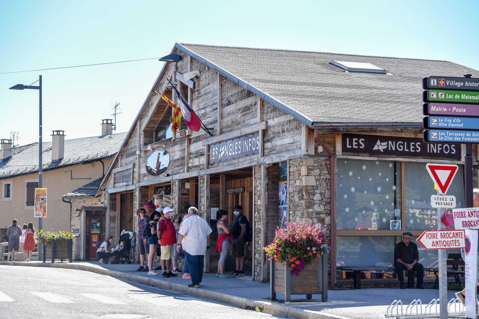 Les Angles, France : 2020 July 19 : People wait in Tourism Ofiice in summer on Les Angles ski resort city in Sunny day.  les Angles, France.