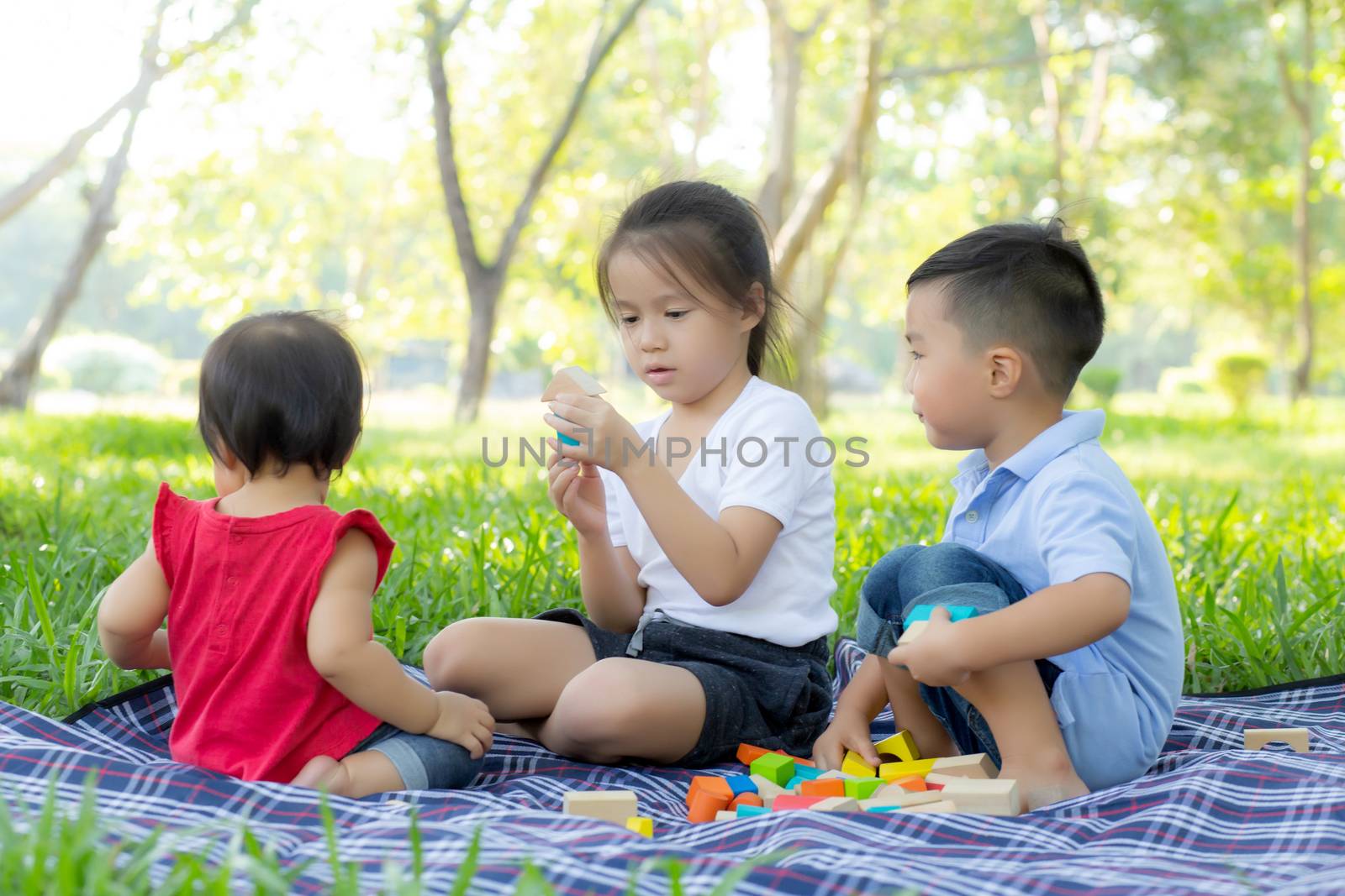 Little boy and girl is playing for idea and inspiration with toy by nnudoo