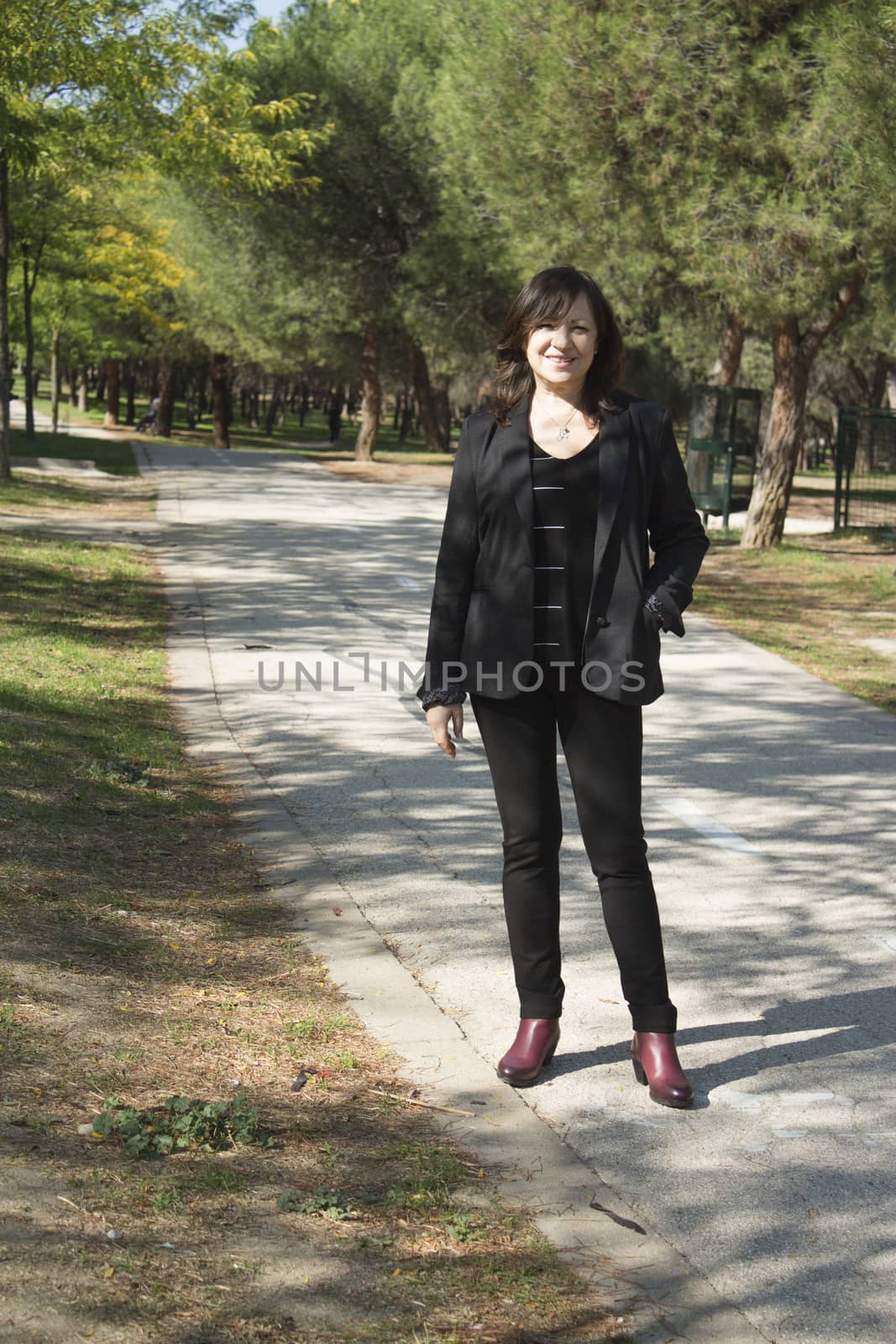 Mature woman in positive attitude sitting and standing