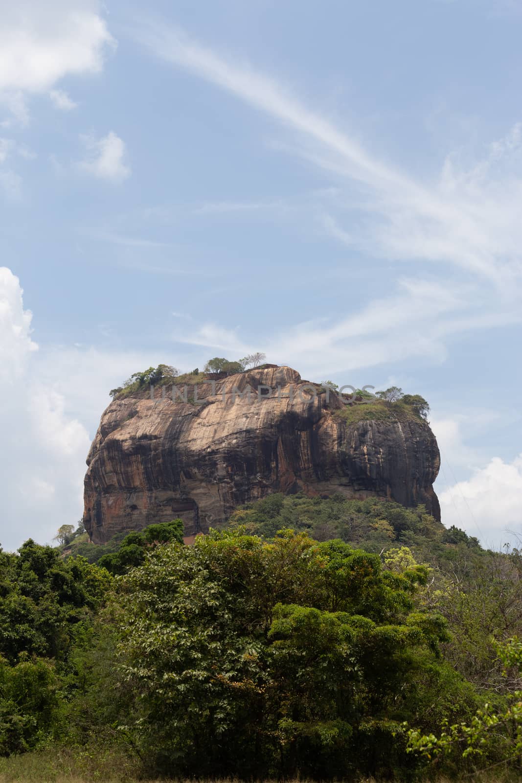 Sigiriya Rock Sri Lanka photographed from rear above forest with blue sky by kgboxford