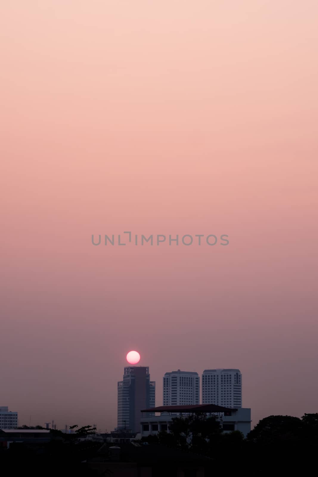 Light of the sun behind the high-rise building in the morning