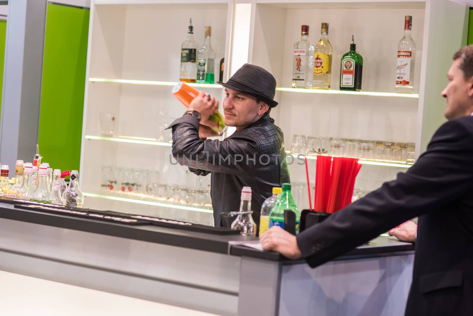 A experienced barman is preparing and serving a colorful cocktail at the Amper convention at the Bno Exhibition Center. czech Republic