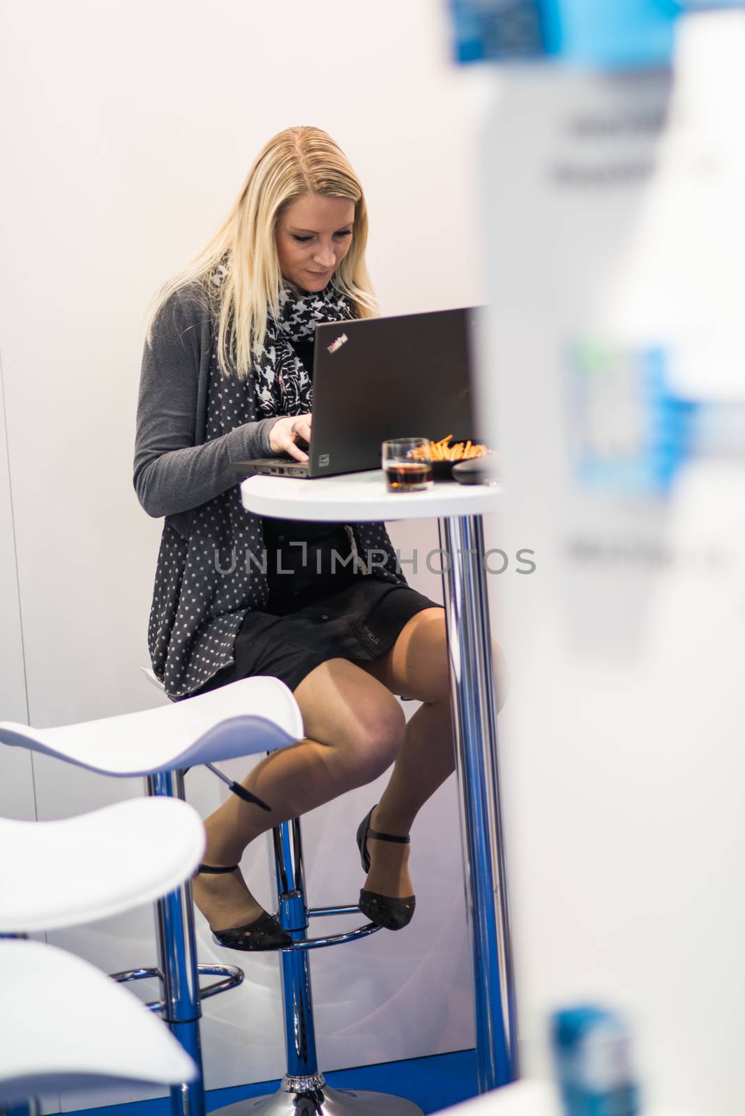 Young woman working with her computer at the Amper convention at the Bno Exhibition Center. czech Republic