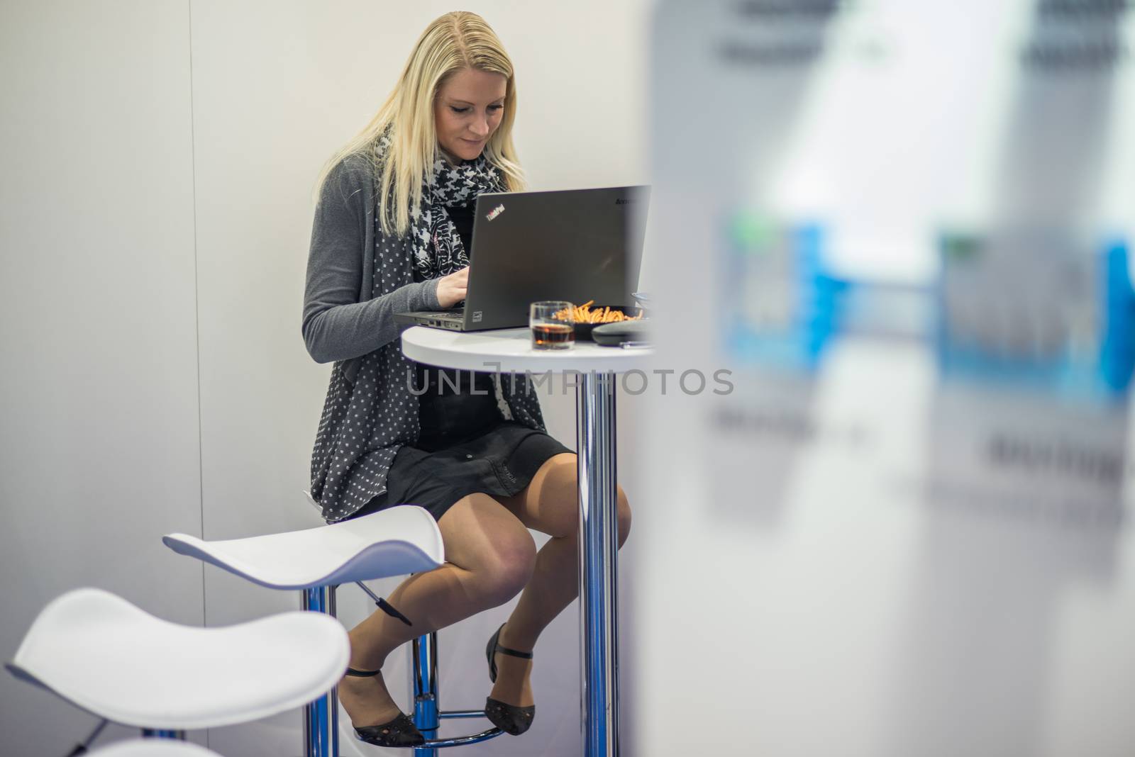 Young woman working with her computer at the Amper convention at the Bno Exhibition Center. czech Republic