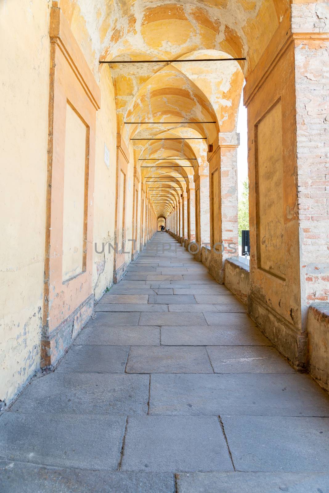 Bologna, Emilia-Romagna/Italy - 19.08.2020: The historical and longest arcade in the world, up to the church Santuario della Madonna di San Luca in Bologna with columns on the right side and a smooth floor.