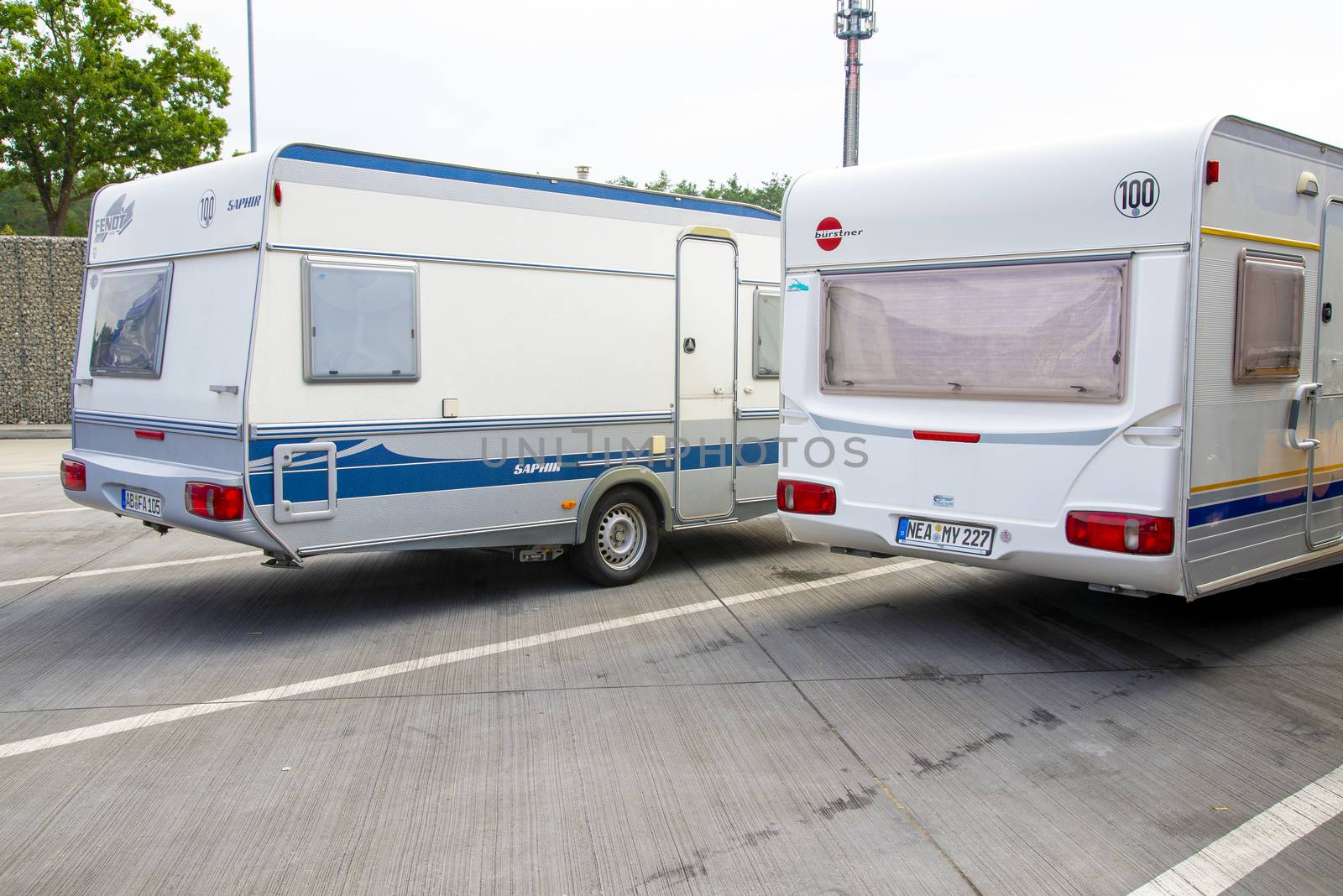 Berlin, Berlin/Germany - 15.08.2020: Two single-axle caravans parked side by side on a freeway parking lot.