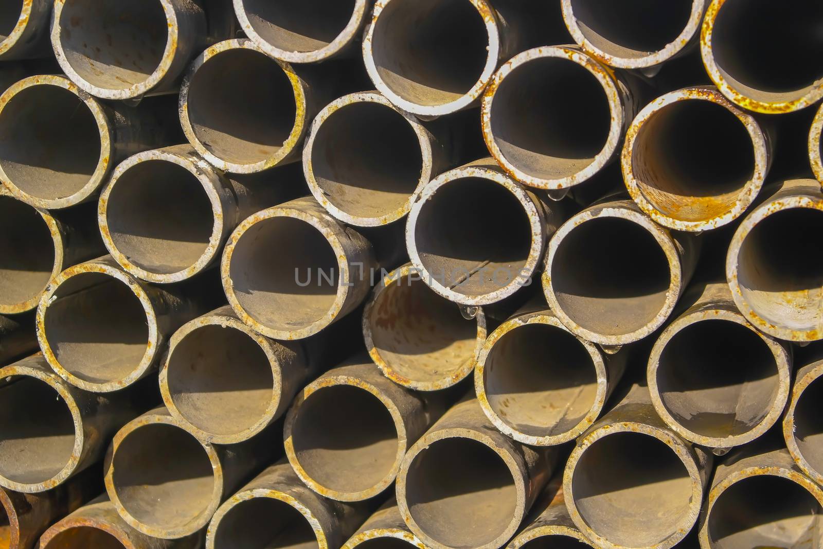 Stack of new metal pipes. Industrial material.
