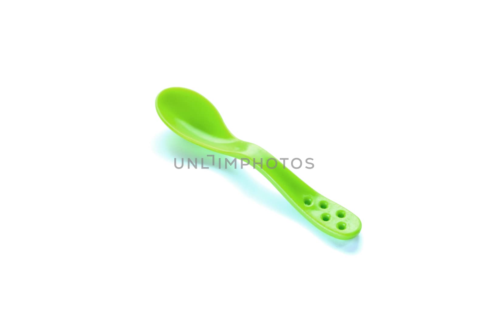 children's green plastic spoon isolated