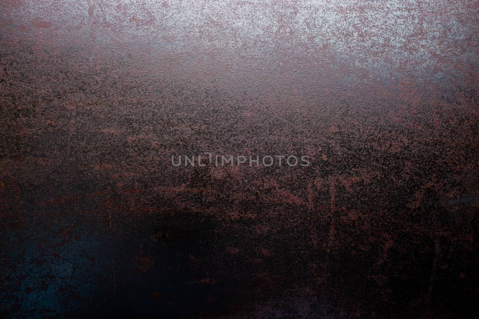 rusted black steel sheet surface covered with machine oil in flat lay perspective