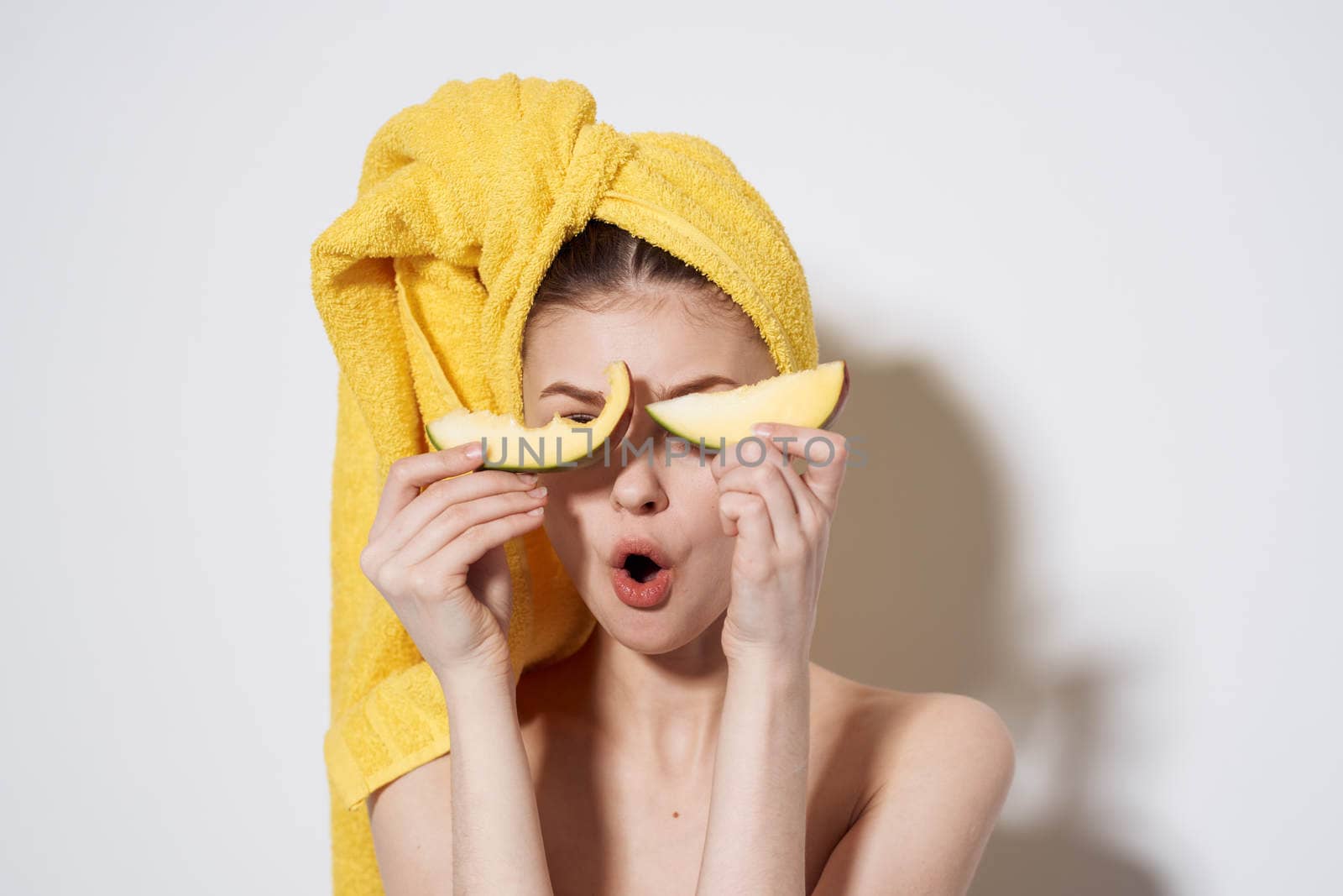 Woman with mango in hands bared shoulders towel on head exotic fruits bared shoulders by SHOTPRIME