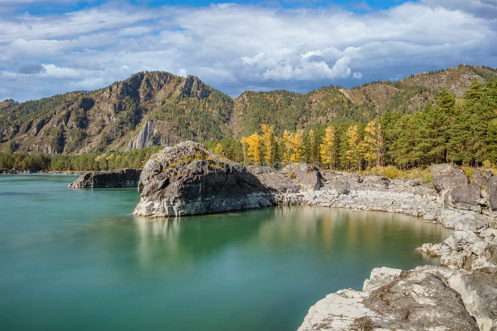 Beautiful view of a small cove on the Katun river in Altai mountains, Siberia, Russia. Long exposure. Smooth turquoise water in the foreground and blue cloudy sky and mountains as a background by DamantisZ