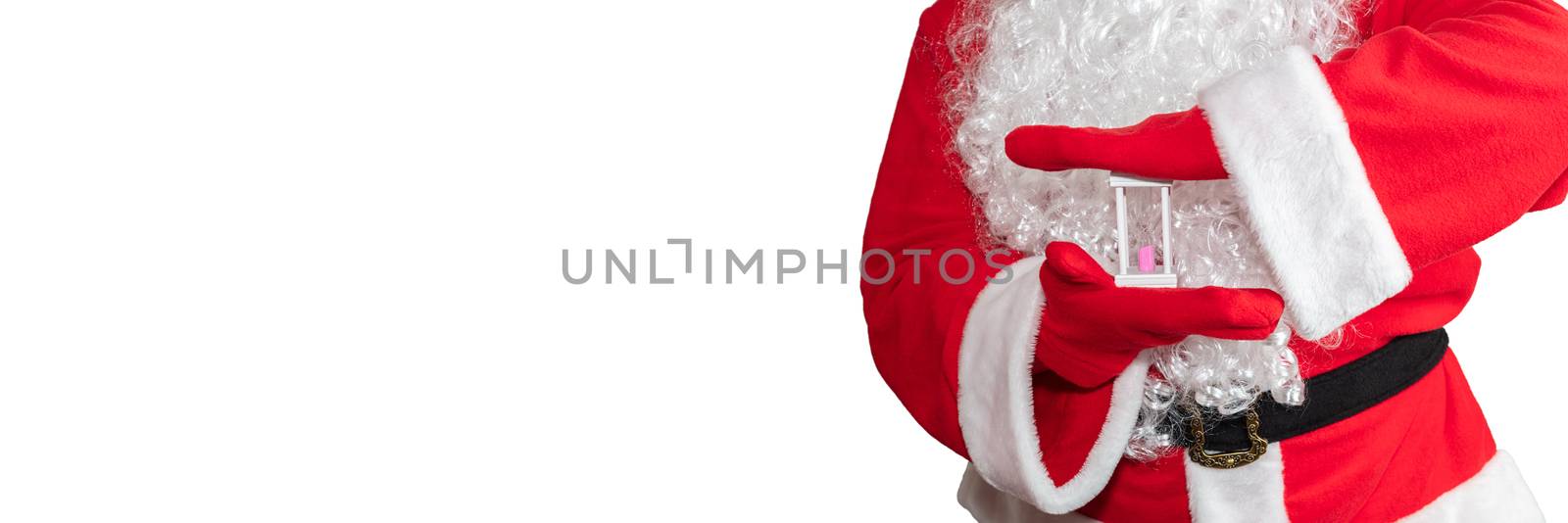 Santa Claus holding a white sand clock with both hands. Time is out. New year's eve concept. Isolated on white background. Banner size, copy space by DamantisZ