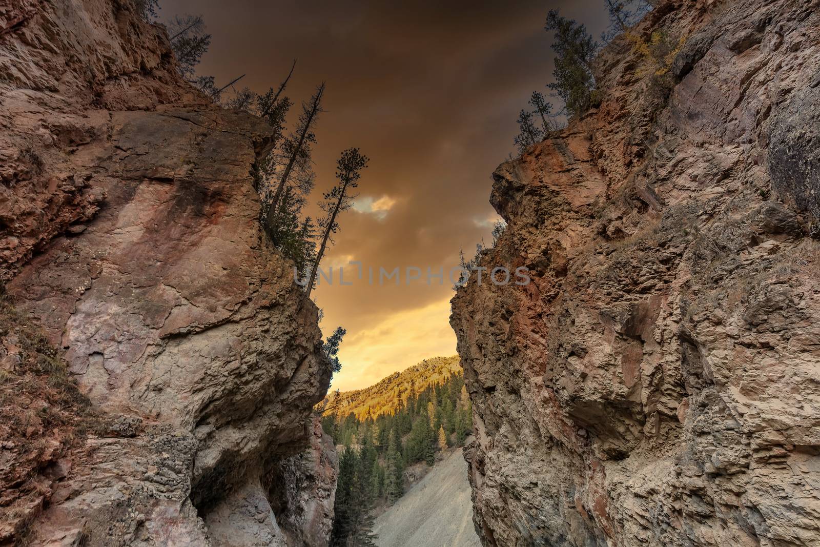 Altai mountains. The so called Red Gates. Beautiful highland landscape. Red mountains in the foreground. Dark orange sunset sky as a background. Russia. Siberia