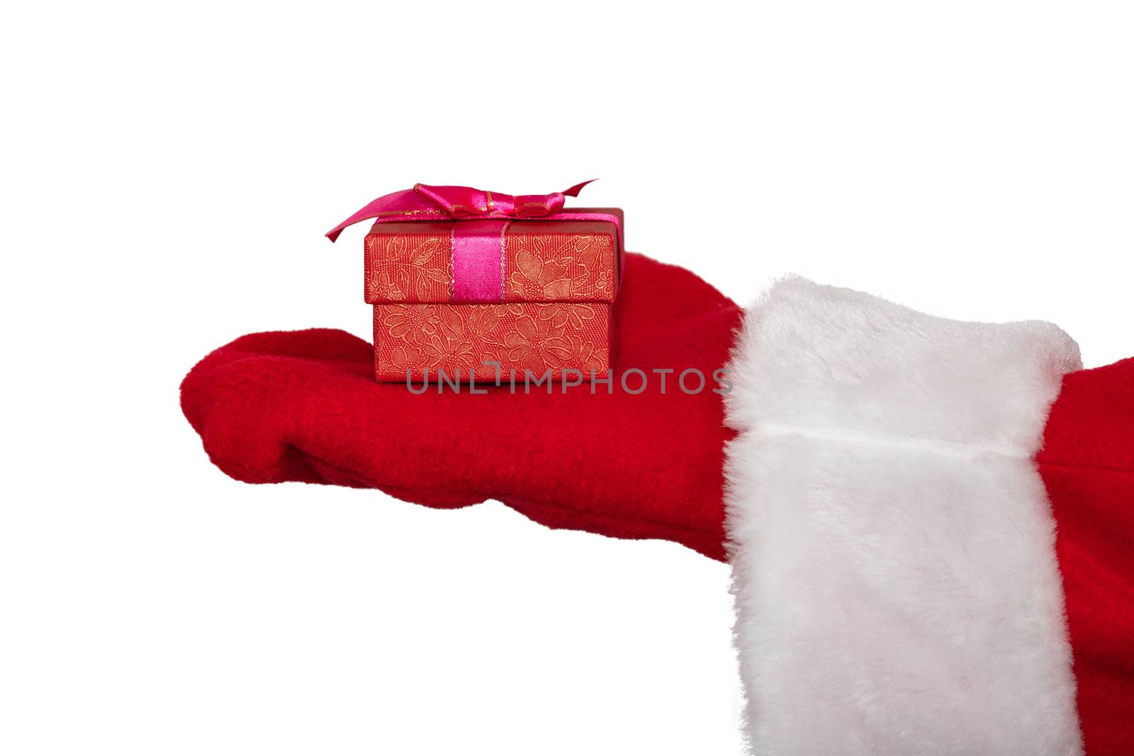 Santa Claus's hand holding a red box with a ribbon. Christmas gift concept. Isolated on white background by DamantisZ