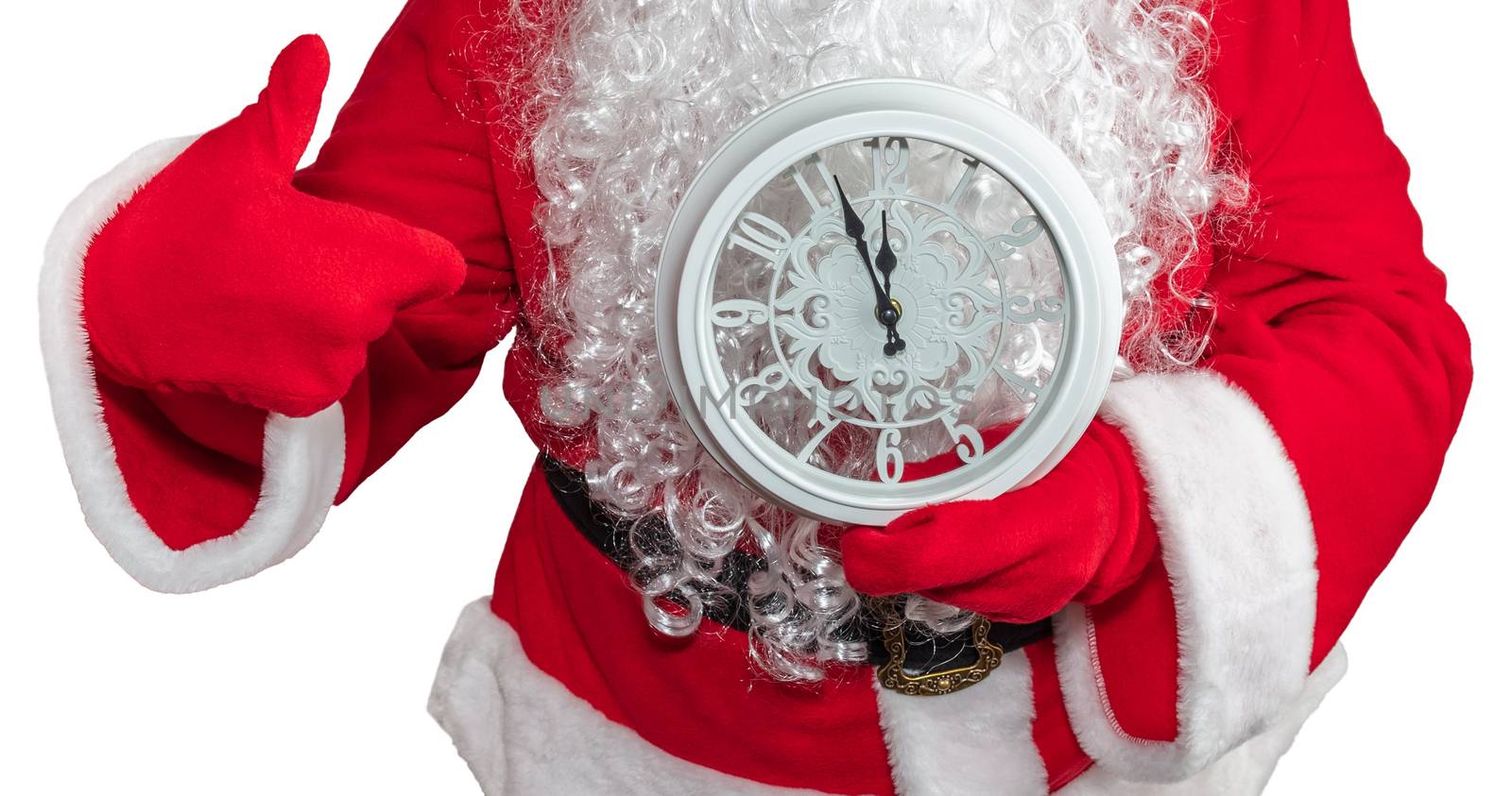 Santa Claus holding a white clock which shows five minutes to midnight and he is pointing at it. New year's eve concept. Isolated on white background.
