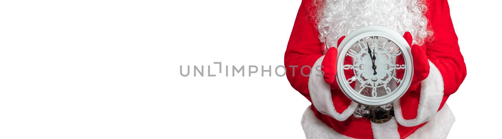 Santa Claus holding a white clock with both hands. The clock shows five minutes to midnight. New year's eve concept. Isolated on white background. Banner size, copy space.