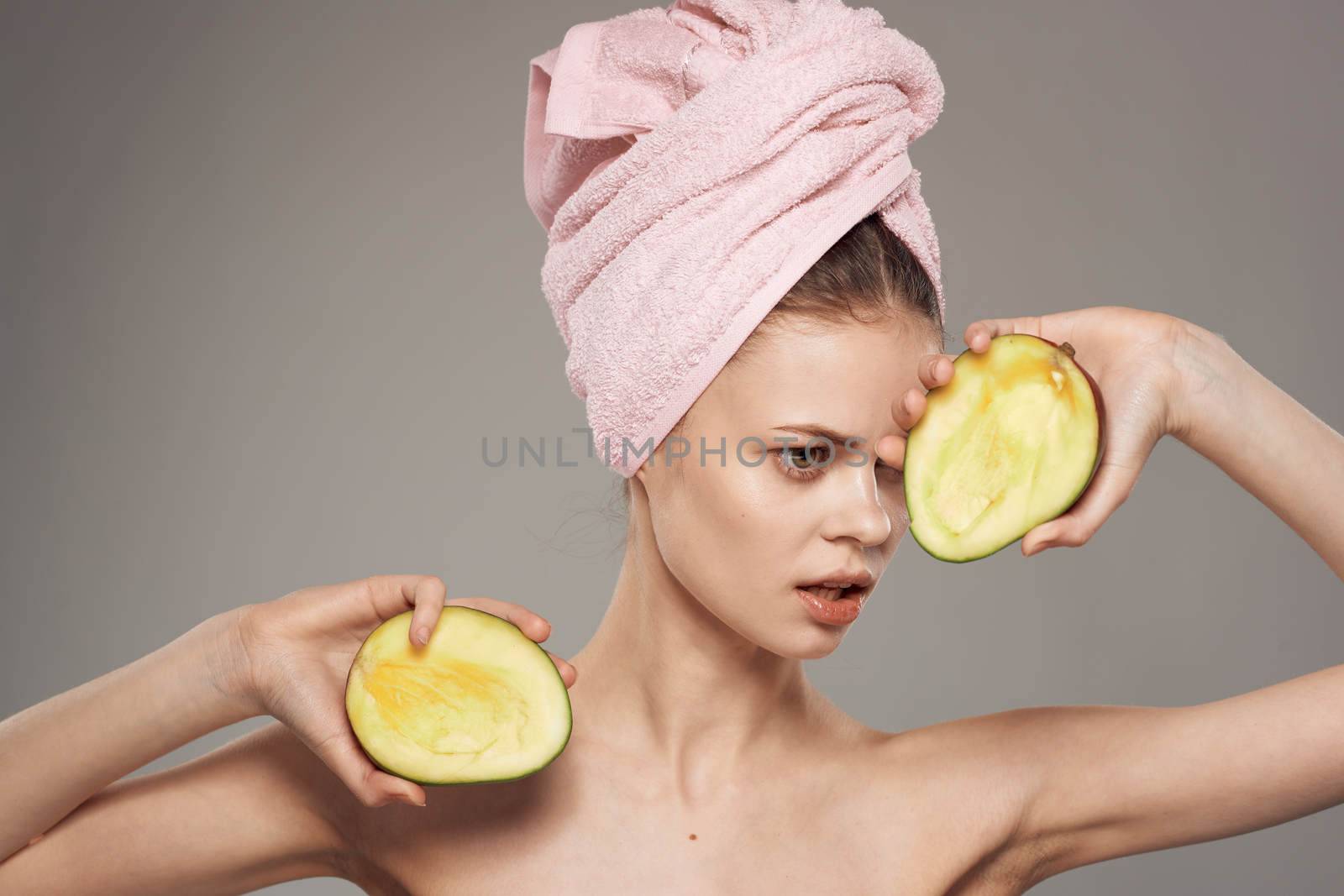 emotional woman with bare shoulders spa treatments clean skin and health mango in hands by SHOTPRIME