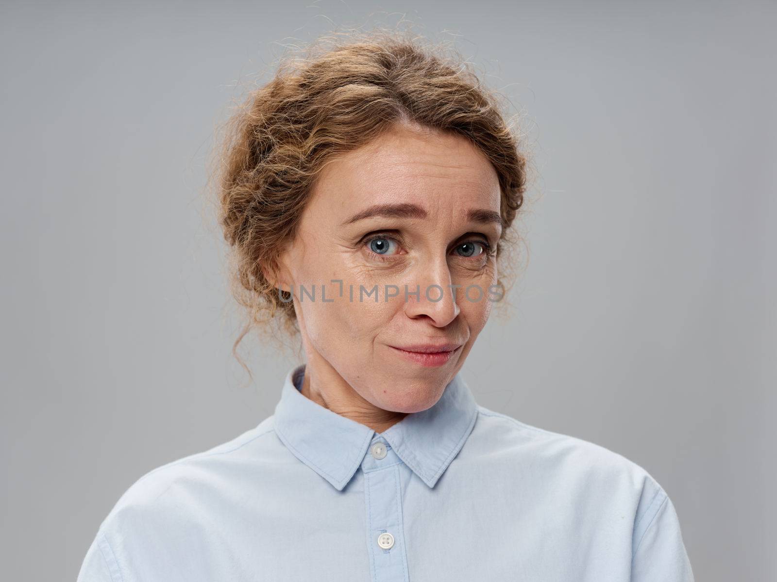 Portrait of an elderly woman in a shirt close-up beautiful face