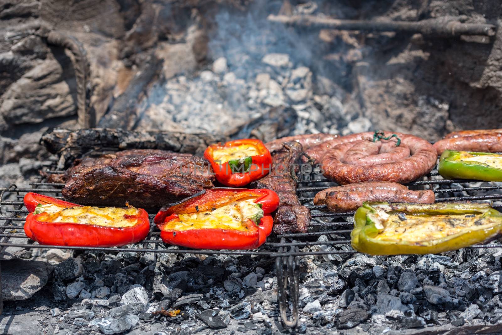 Closeup take of a traditional Argentinian and Uruguayan barbecue and peppers ehit eggs and cheese.