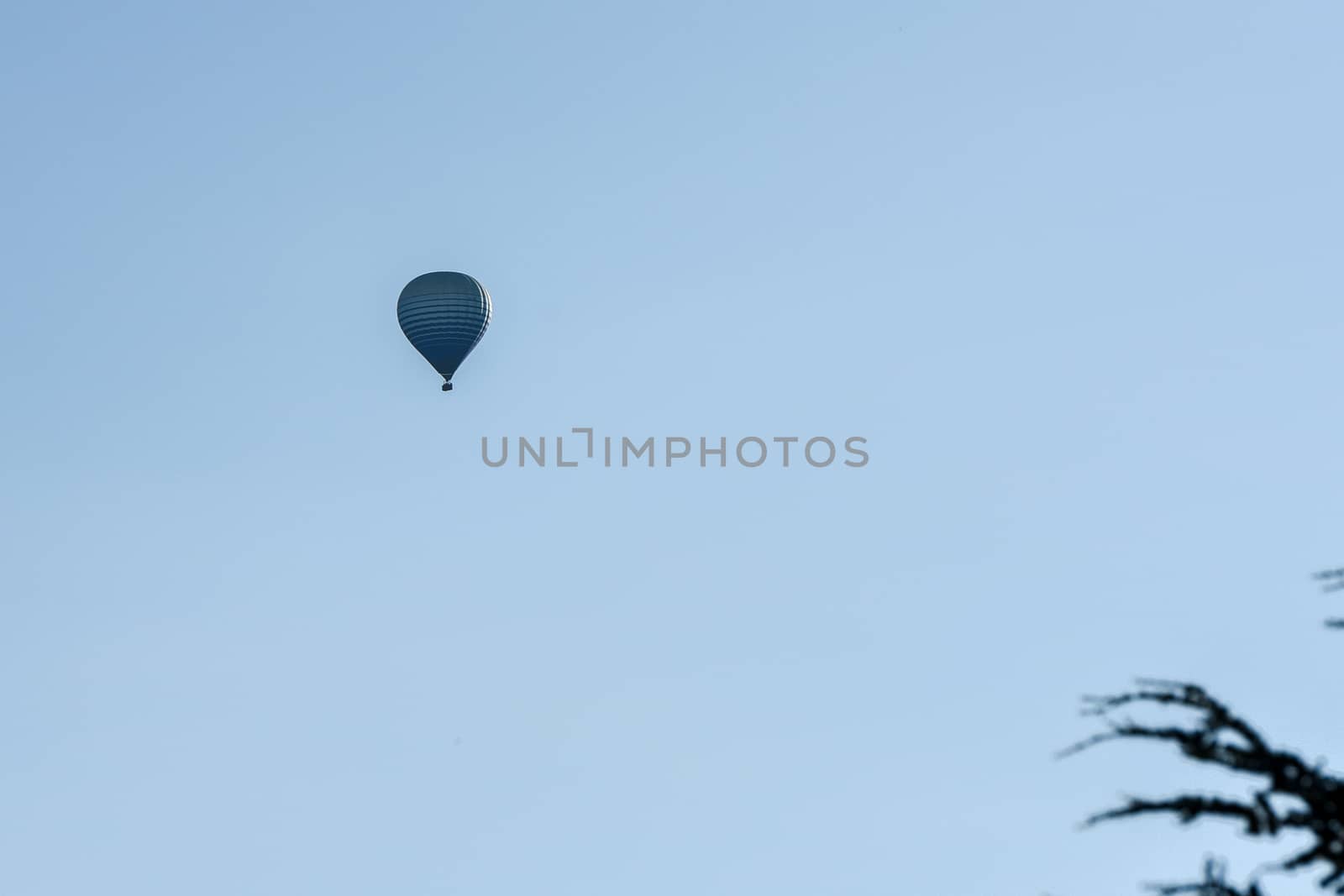 Colorful hot air balloons flying over the mountain in Puig Cerda, Spain.